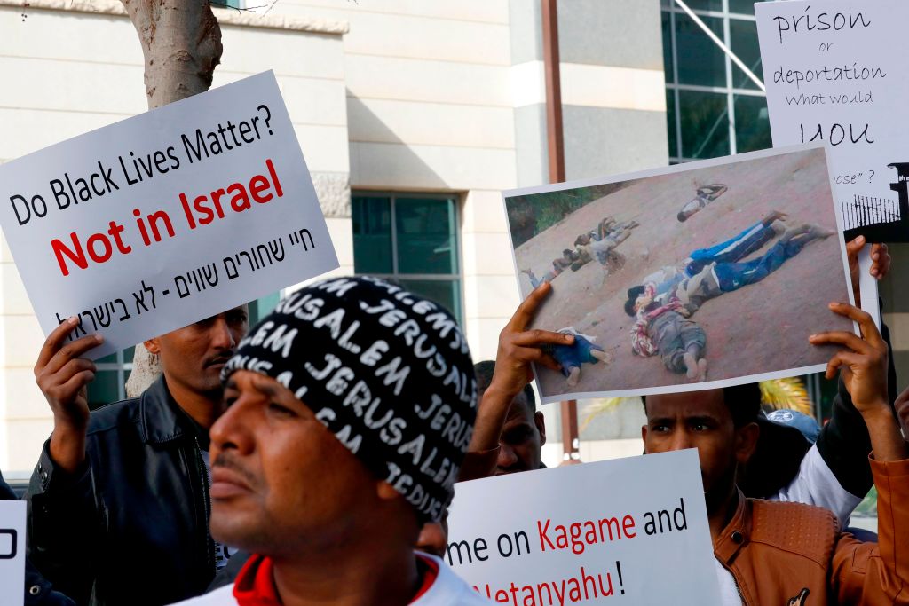 African migrants demonstrate against the Israeli government's policy to forcibly deport African refugees and asylum seekers from Israel to Uganda and Rwanda, outside the Rwanda embassy on January 22, 2018 in the Israeli city of Herzliya. (CREDIT: JACK GUEZ/AFP/Getty Images)
