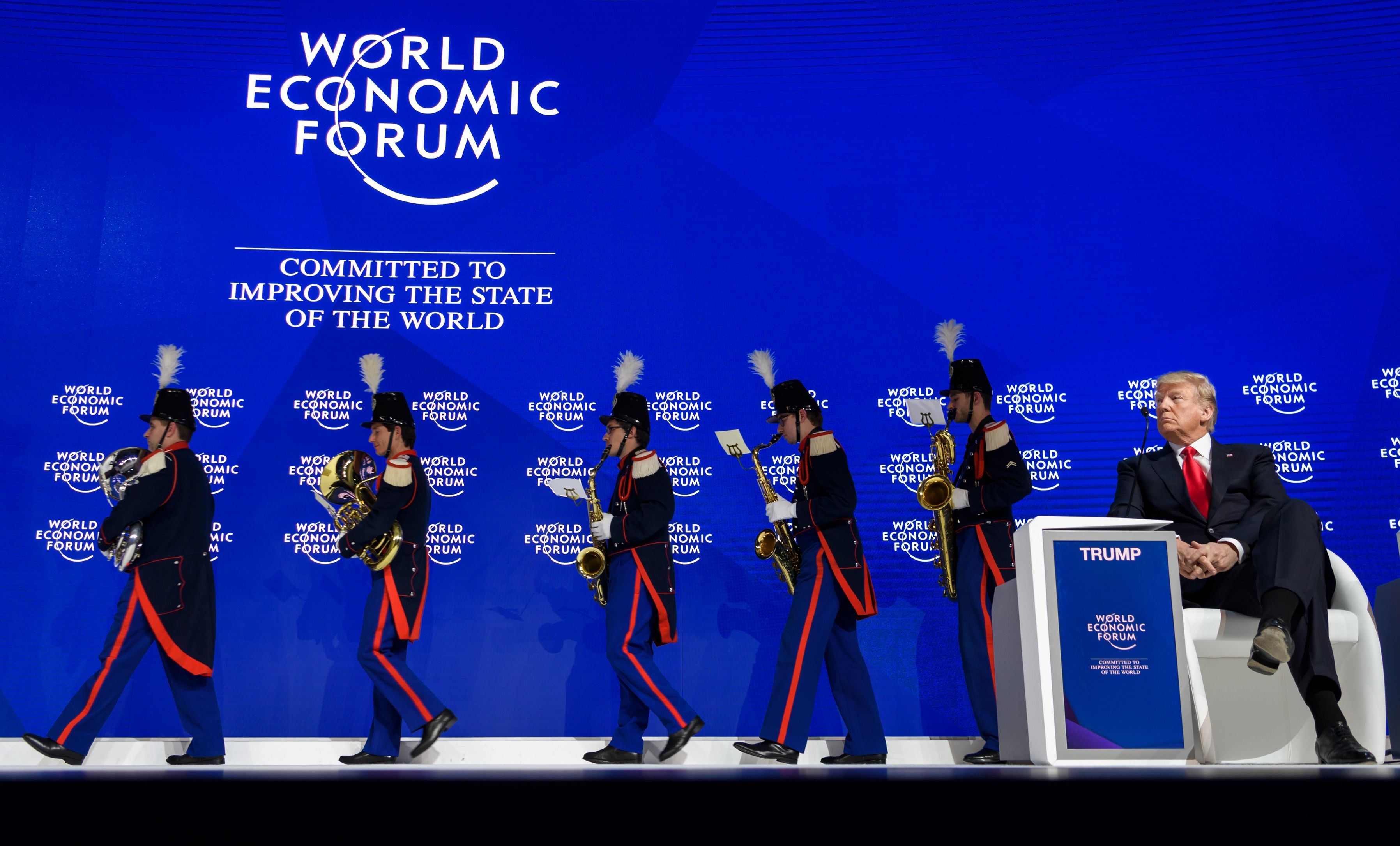 US President Donald Trump watches a band leaving the stage before delivering his speech during the World Economic Forum (WEF) annual meeting on January 26, 2018 in Davos. (CREDIT: FABRICE COFFRINI/AFP/Getty Images)