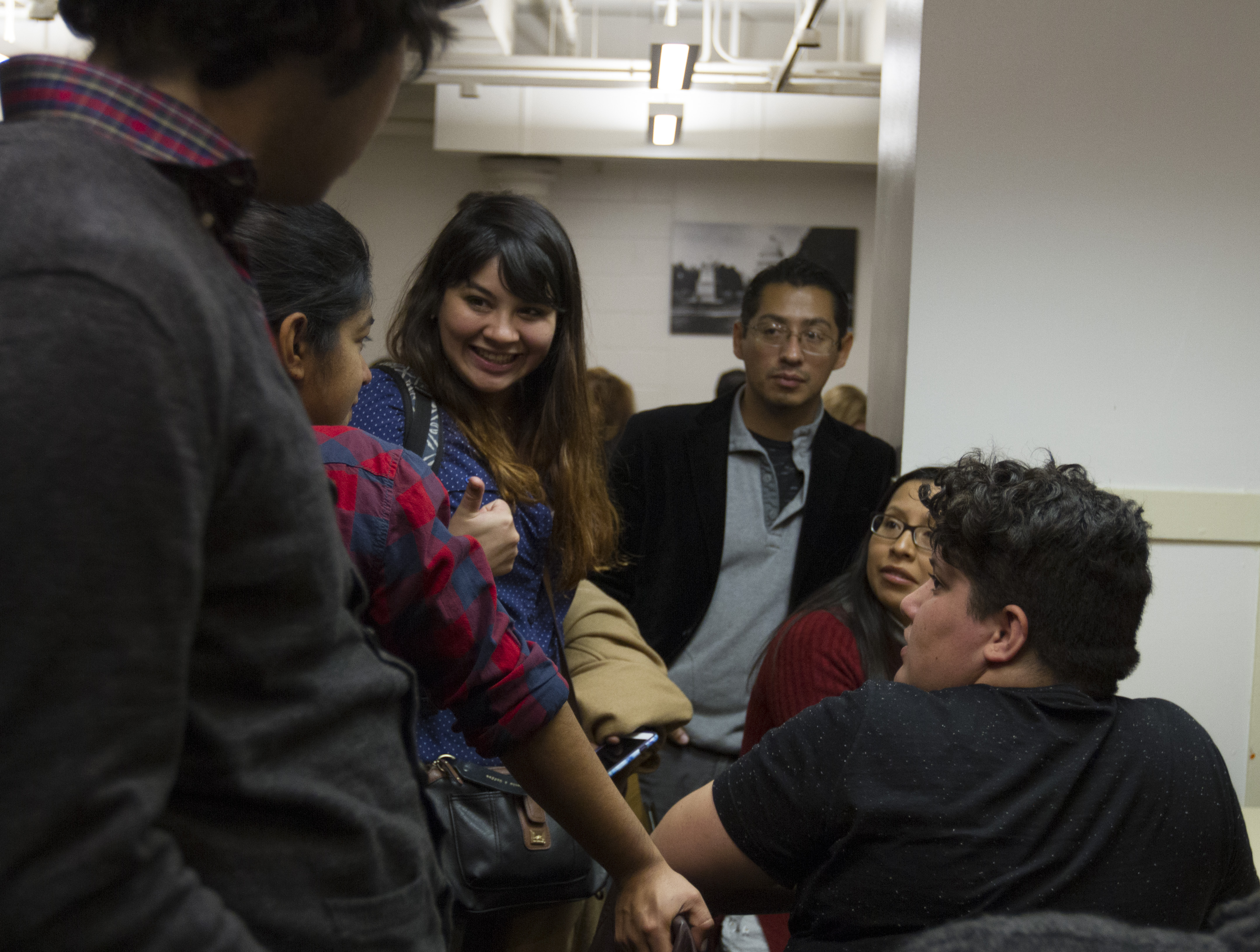 Leaders Reyna Montoya and Maxima Guerrero try to lift the spirits of a disheartened group of DACA recipients and advocates after a hard meeting with a Representative on Dec. 6, 2017. (Credit: Megan Janetsky)