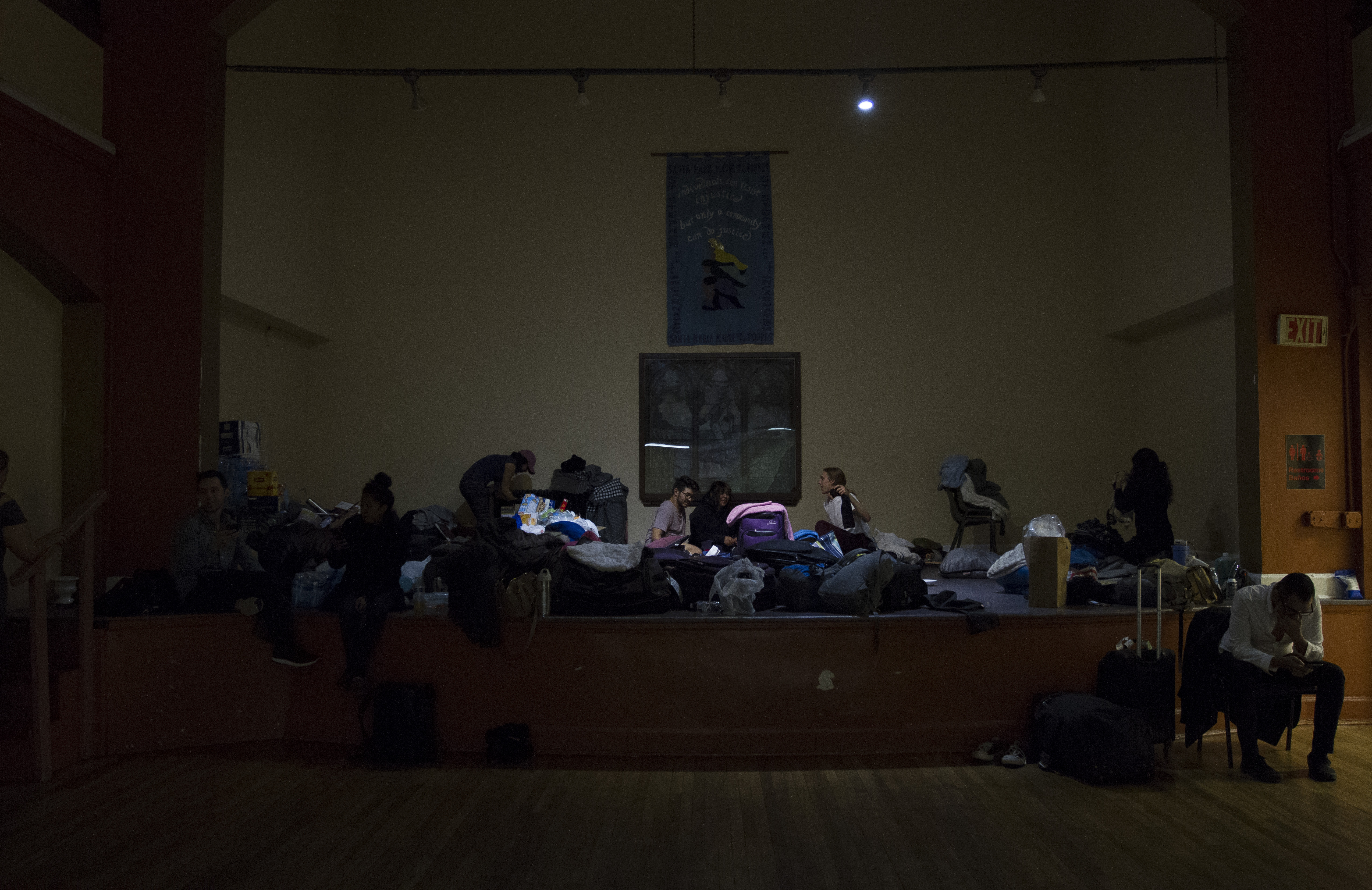 By night, the group of 'Dreamers' sleep on the floor of a local D.C. church, unwinding after a long day on the Hill by chatting, playing games, keying through social media and doing homework on Dec. 6, 2017. (Credit: Megan Janetsky)