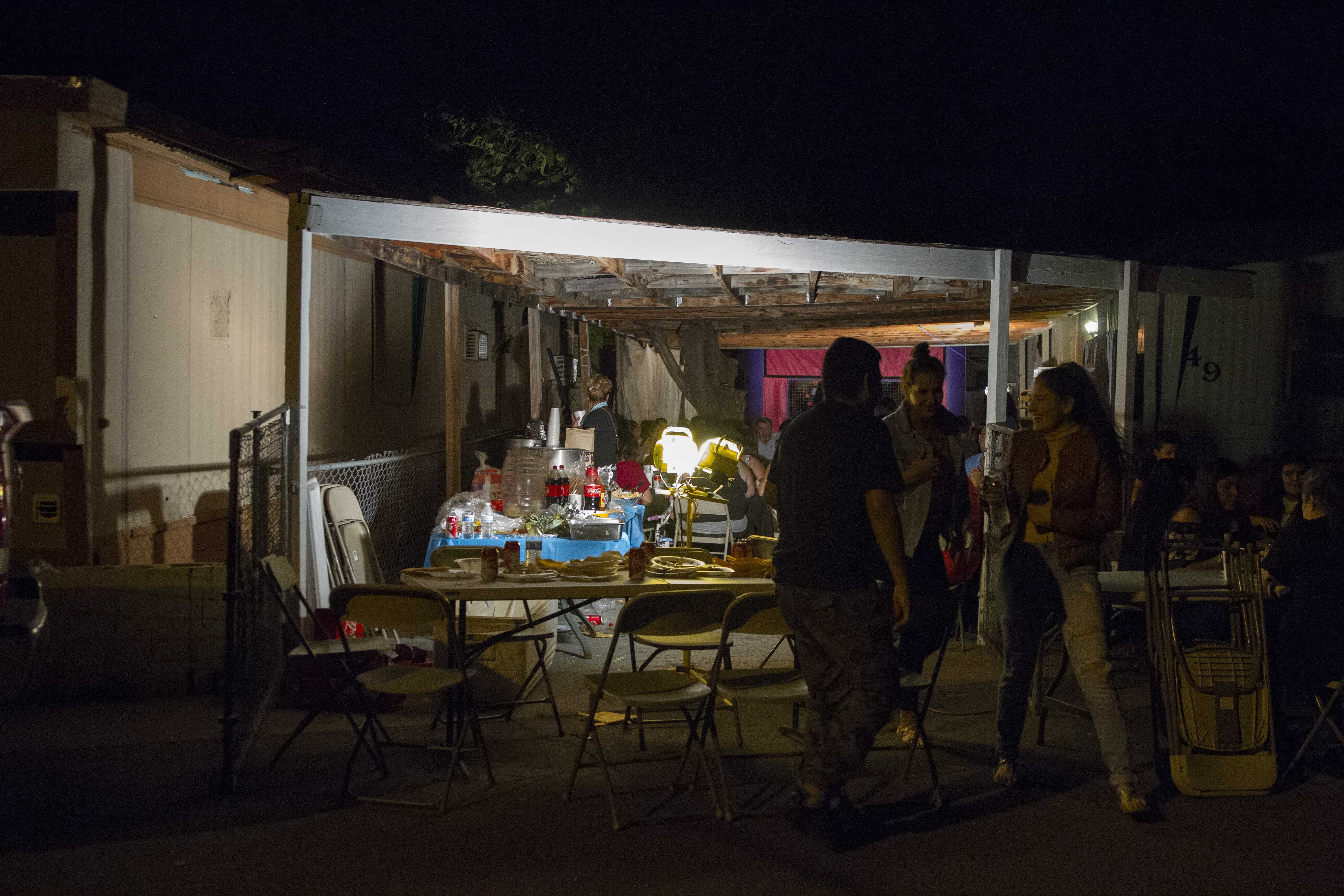 Throngs of people walk in and out of the Pena's trailer home patio for her mom's birthday party on Nov. 25, 2017 in Paradise Valley, Arizona. (CREDIT: Megan Janetsky)