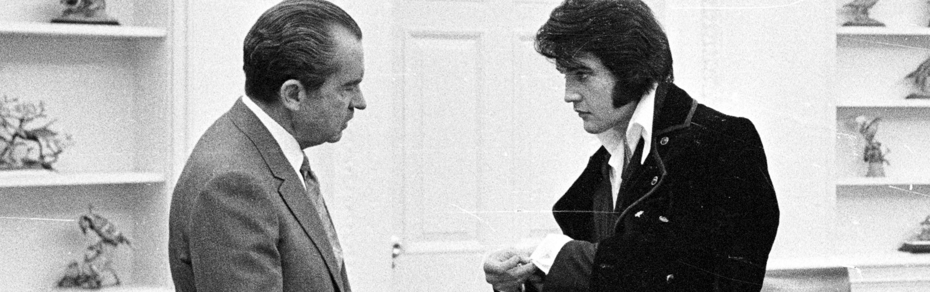 Elvis Presley shows President Richard Nixon his cuff links December 21, 1970 at the White House. (Photo by National Archive/Newsmakers)