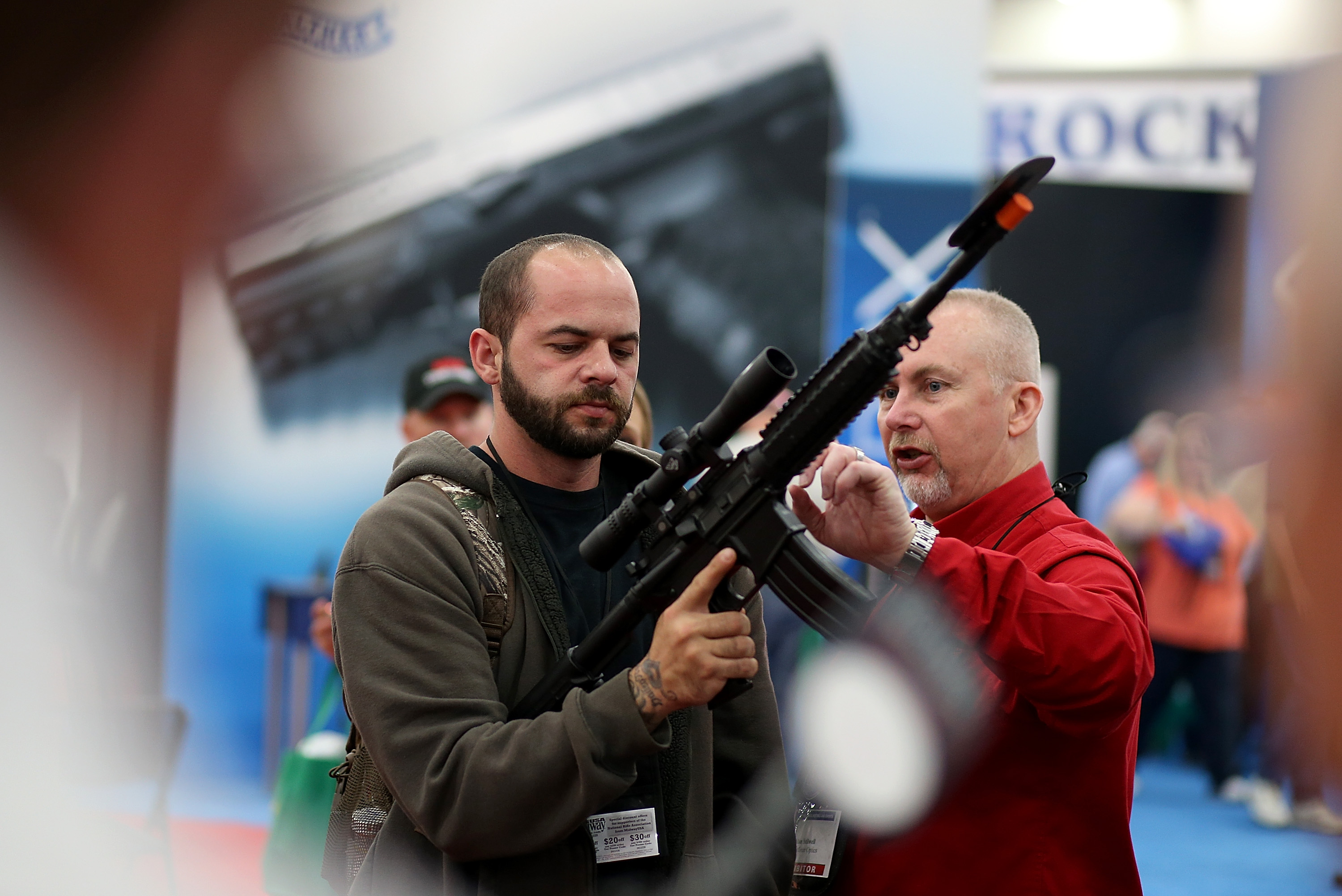 An attendee inspects a scope on an assault rifle during the 2013 NRA Annual Meeting and Exhibits at the George R. Brown Convention Center on May 3, 2013 in Houston, Texas. CREDIT: Justin Sullivan/Getty Images