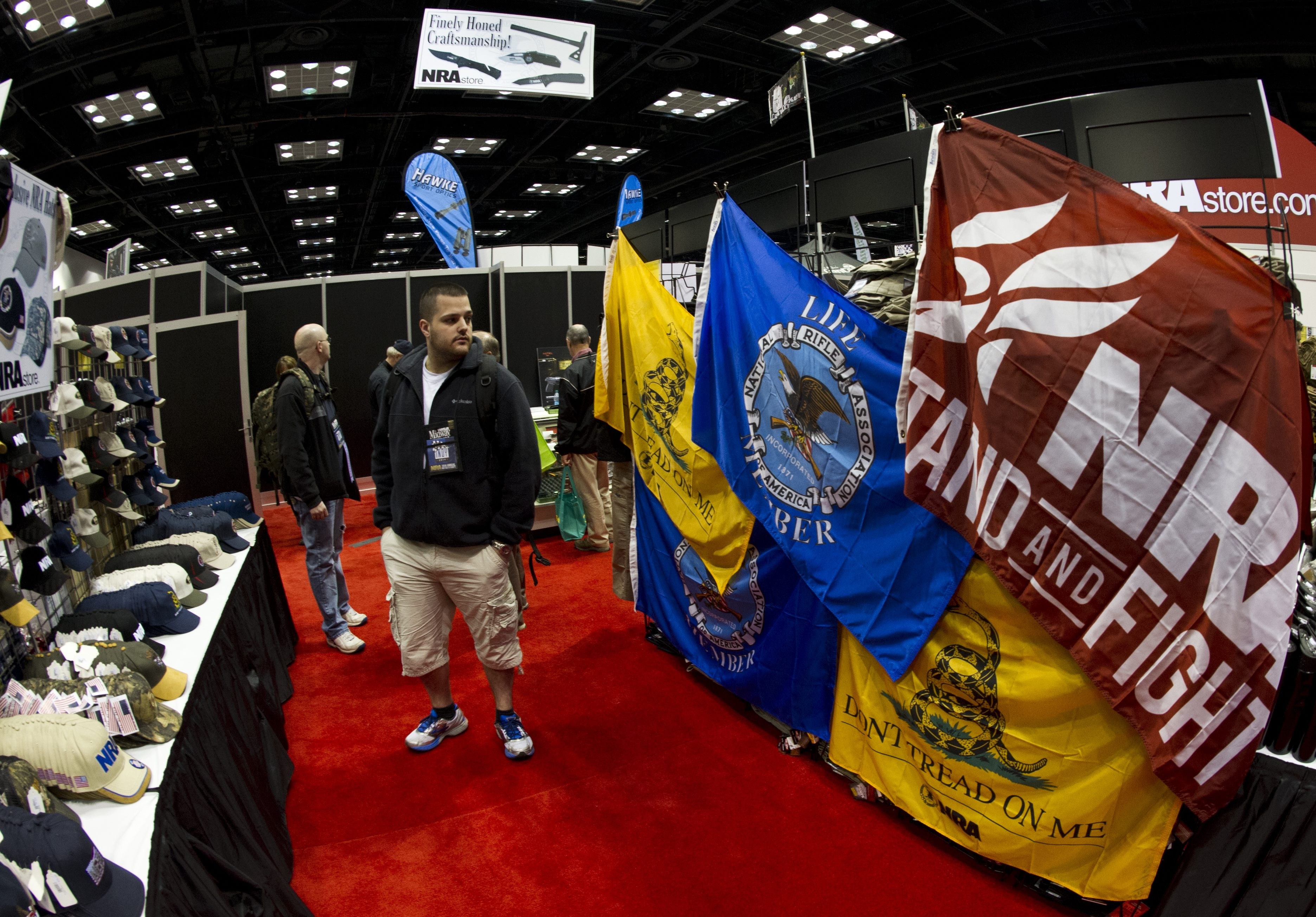 Convention goers peruse merchandise at the 143rd NRA Annual Meetings. CREDIT: AFP PHOTO / Karen BLEIER