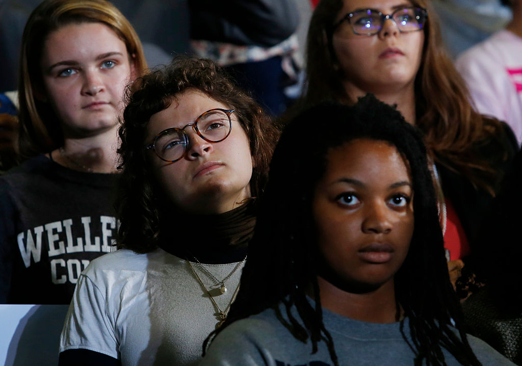 Millennials listen as Hillary Clinton and Bernie Sanders campaign together in Durham New Hampshire, Sept. 28, 2016. CREDIT: Jessica Rinaldi/The Boston Globe via Getty Images