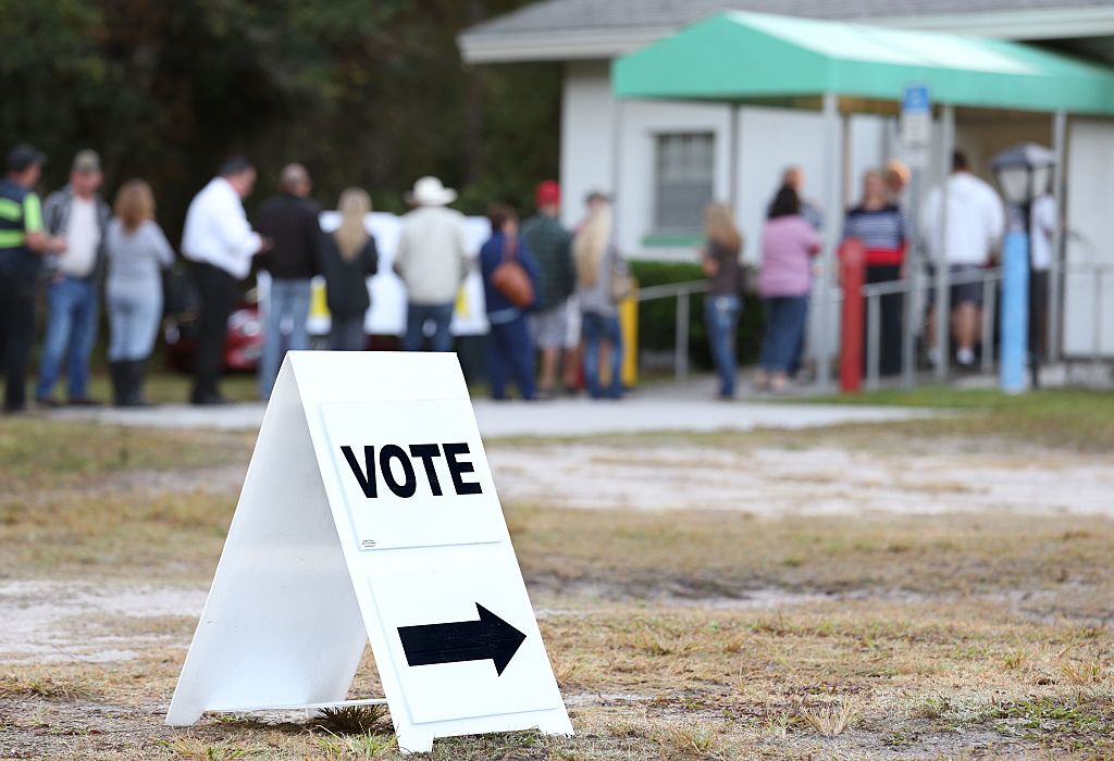 Voters wait in a queue to cast their ballots in the presidential election at a polling station in Christmas, Florida on November 8, 2016. CREDIT: GREGG NEWTON/AFP/Getty Images
