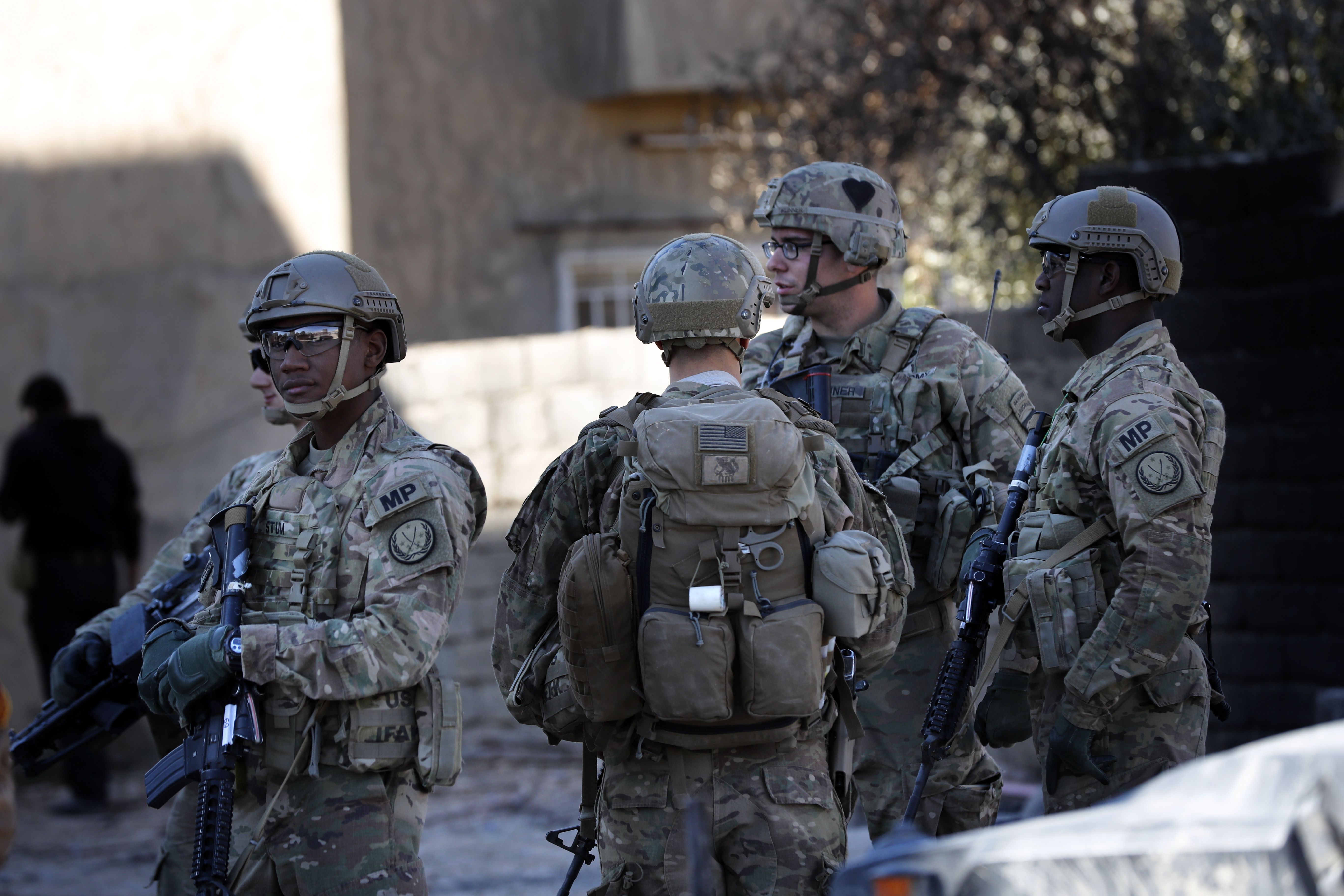 US soldiers stand guard near an Iraqi army base on the outskirts of Mosul, on November 23, 2016.
Forces battling the Islamic State group in northern Iraq cut off the jihadists' last supply line from Mosul to Syria, trapping them in the city for a bloody last stand. (CREDIT: Thomas Coex/AFP/Getty Images)