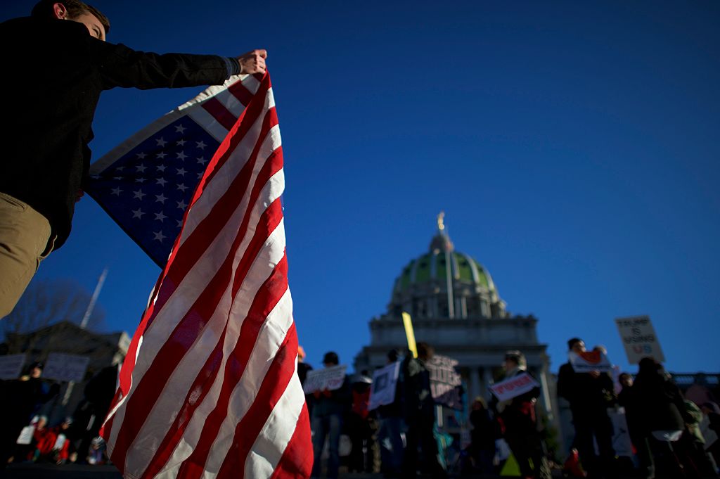 Joey Betz, 19, joins protestors demonstrating outside the Pennsylvania Capitol Building before electors arrive to cast their votes from the election at December 19, 2016 in Harrisburg, Pennsylvania. (Photo by Mark Makela/Getty Images)