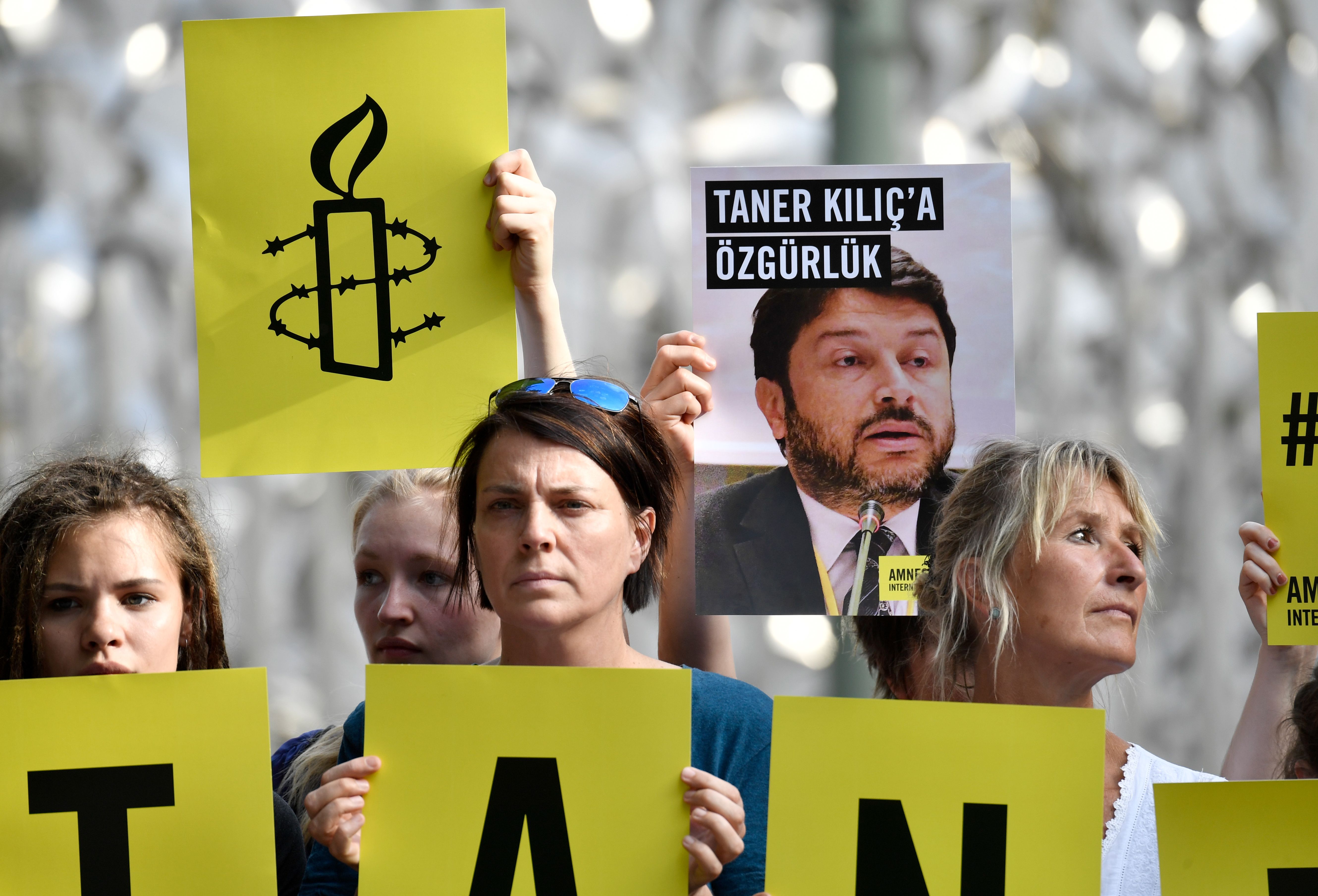 Activists of Amnesty International stage a protest against the detention of the head of Amnesty International in Turkey, Taner Kilic, in front of the Turkish Embassy in Berlin on June 15, 2017. Taner Kilic was arrested in the Turkish province of Izmir along with 22 other lawyers the previous week, and has been charged with membership of a terrorist organisation and remanded in custody pending trial CREDIT: John MacDougall/AFP/Getty Images.