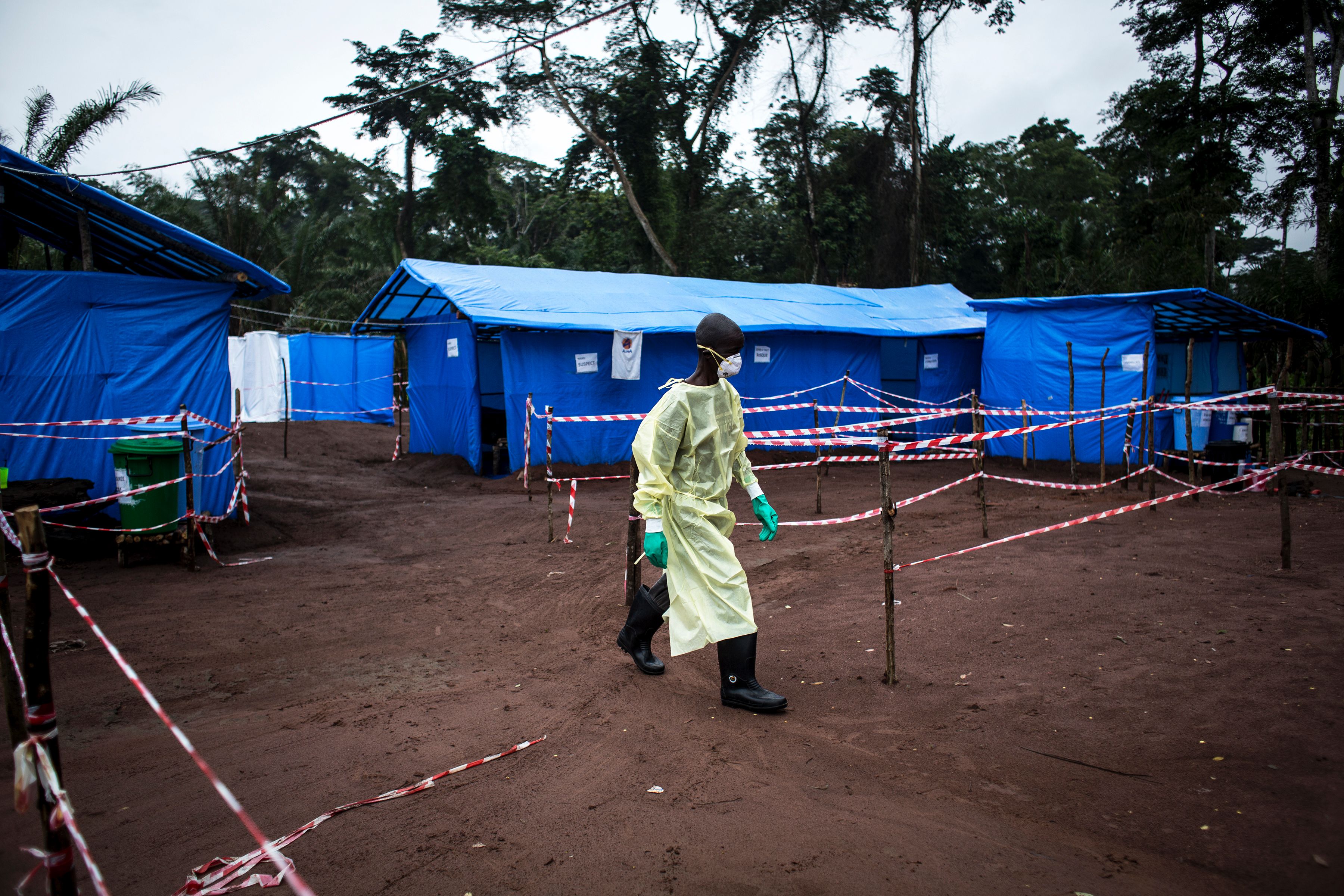 TOPSHOT - worker walks at an Ebola quarantine unit on June 13, 2017 in Muma, after a case of Ebola was confirmed in the village.
(CREDIT: JOHN WESSELS/AFP/Getty Images)