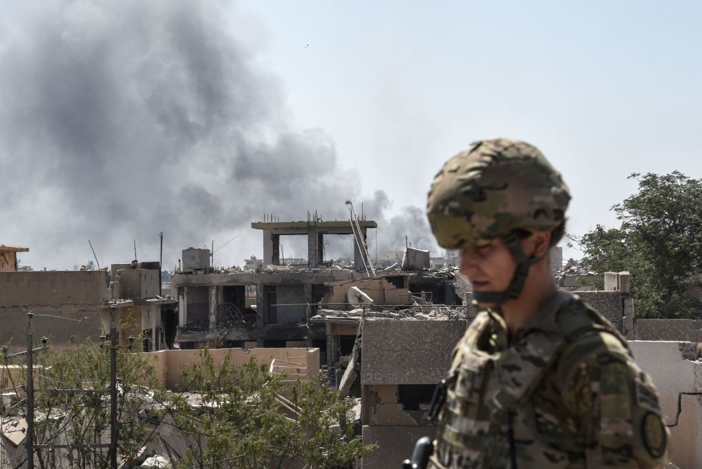 A US soldier advising Iraqi forces is seen in the city of Mosul on June 21, 2017, during the ongoing offensive by Iraqi troops to retake the last district still held by the Islamic State (IS) group. CREDIT: MOHAMED EL-SHAHED/AFP/Getty Images