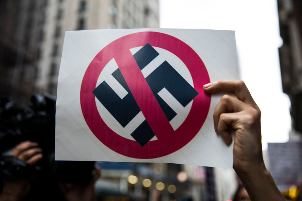 Anti-President Donald Trump protesters carry anti-Nazi signs outside of Trump Tower August 14, 2017 in New York City. (CREDIT: Robert Nickelsberg/Getty Images)