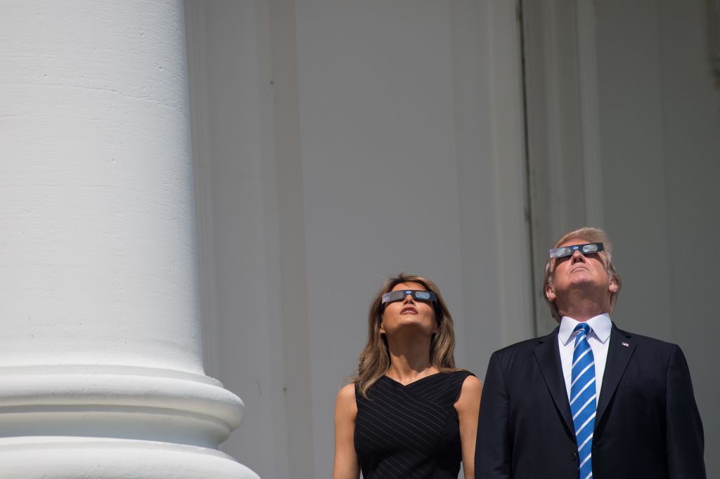 US President Donald Trump and First Lady Melania Trump look up at the partial solar eclipse on August 21, 2017.
Credit: NICHOLAS KAMM/AFP/Getty Images