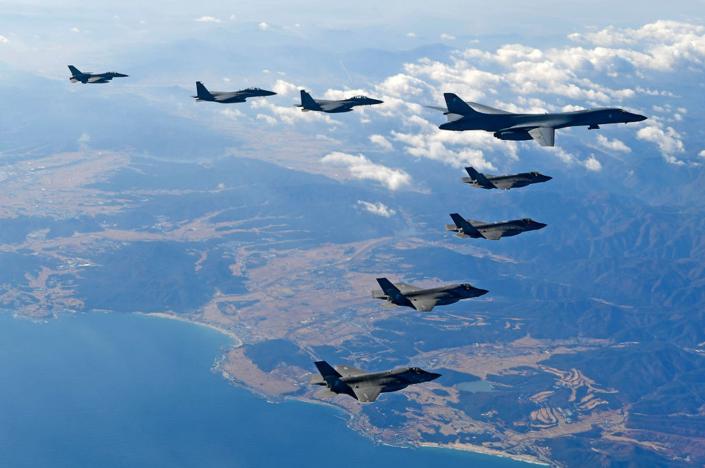 A nuclear-capable B-1 bomber from the USAF flies over South Korea during recent war games (Photo by South Korean Defense Ministry via Getty Images)