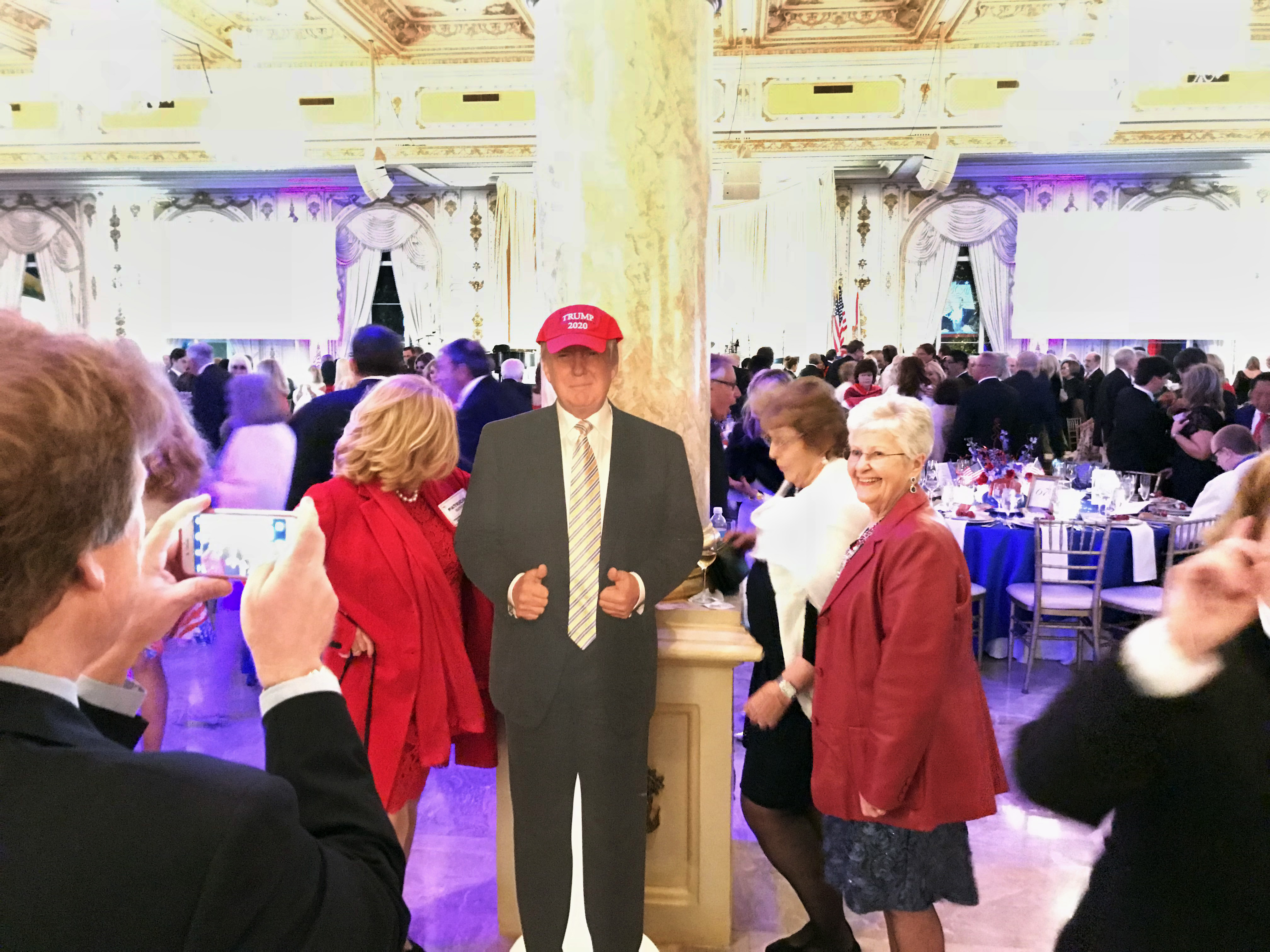 Trump supporters pose with a cardboard cutout at Trump’s Mar-a-Lago Club. CREDIT: David A. Fahrenthold/The Washington Post via Getty Images