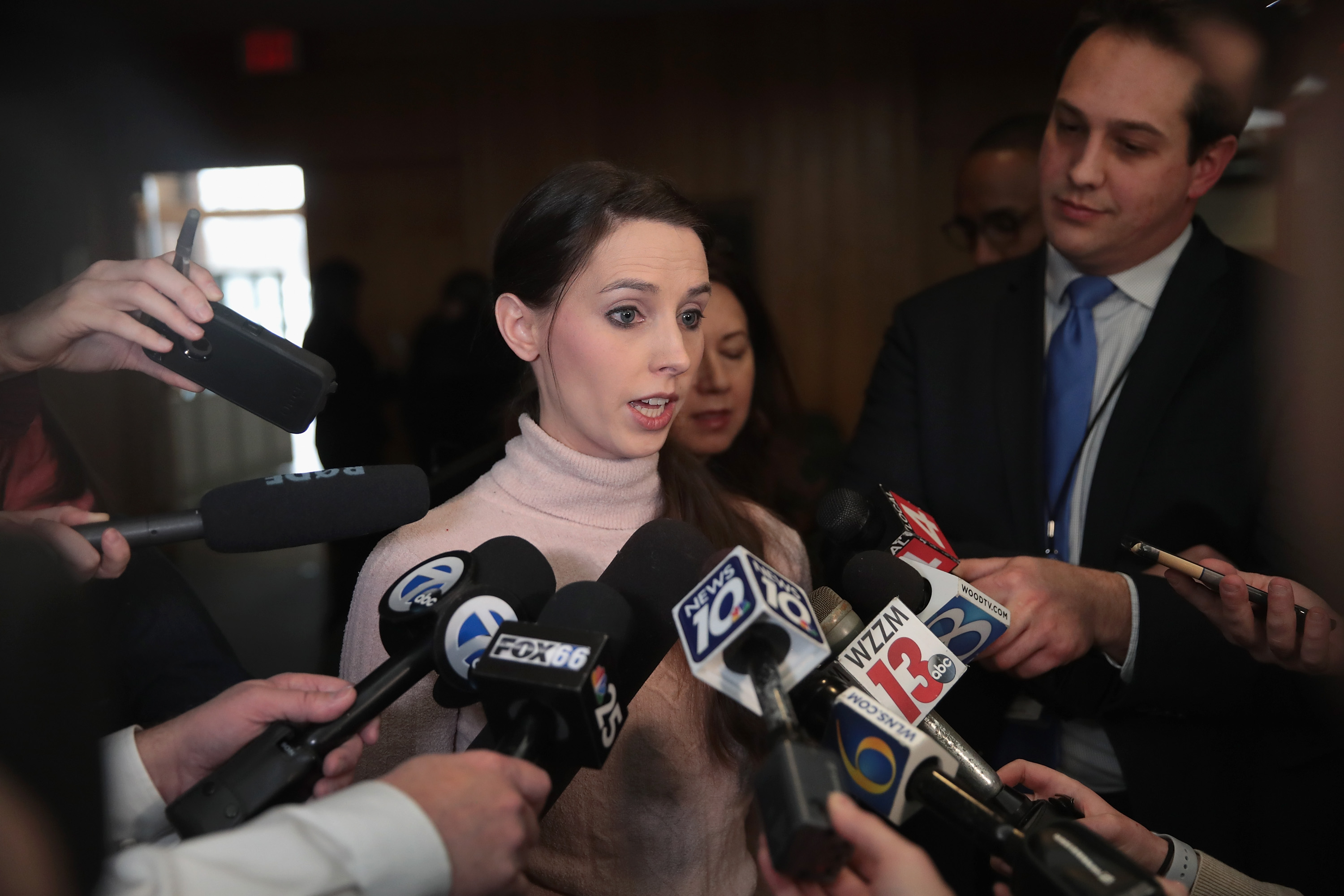 CHARLOTTE, MI - FEBRUARY 05: Rachael Denhollander, who was sexually abused by Larry Nassar beginning when she was 15-years-old, speaks to the press after Nassar's sentencing hearing in Eaton County Circuit Court on February 5, 2018 in Charlotte, Michigan. Nassar has been accused of sexually assaulting more than 150 girls and young women while he was a physician for USA Gymnastics and Michigan State University. At the hearing Nassar was sentenced to 40 to 125 years in prison. He is currently serving a 60-year sentence in federal prison for possession of child pornography. Last month a judge in Ingham County, Michigan sentenced Nassar to 40 to 175 years in prison after he plead guilty to sexually assaulting seven girls. (Photo by Scott Olson/Getty Images)