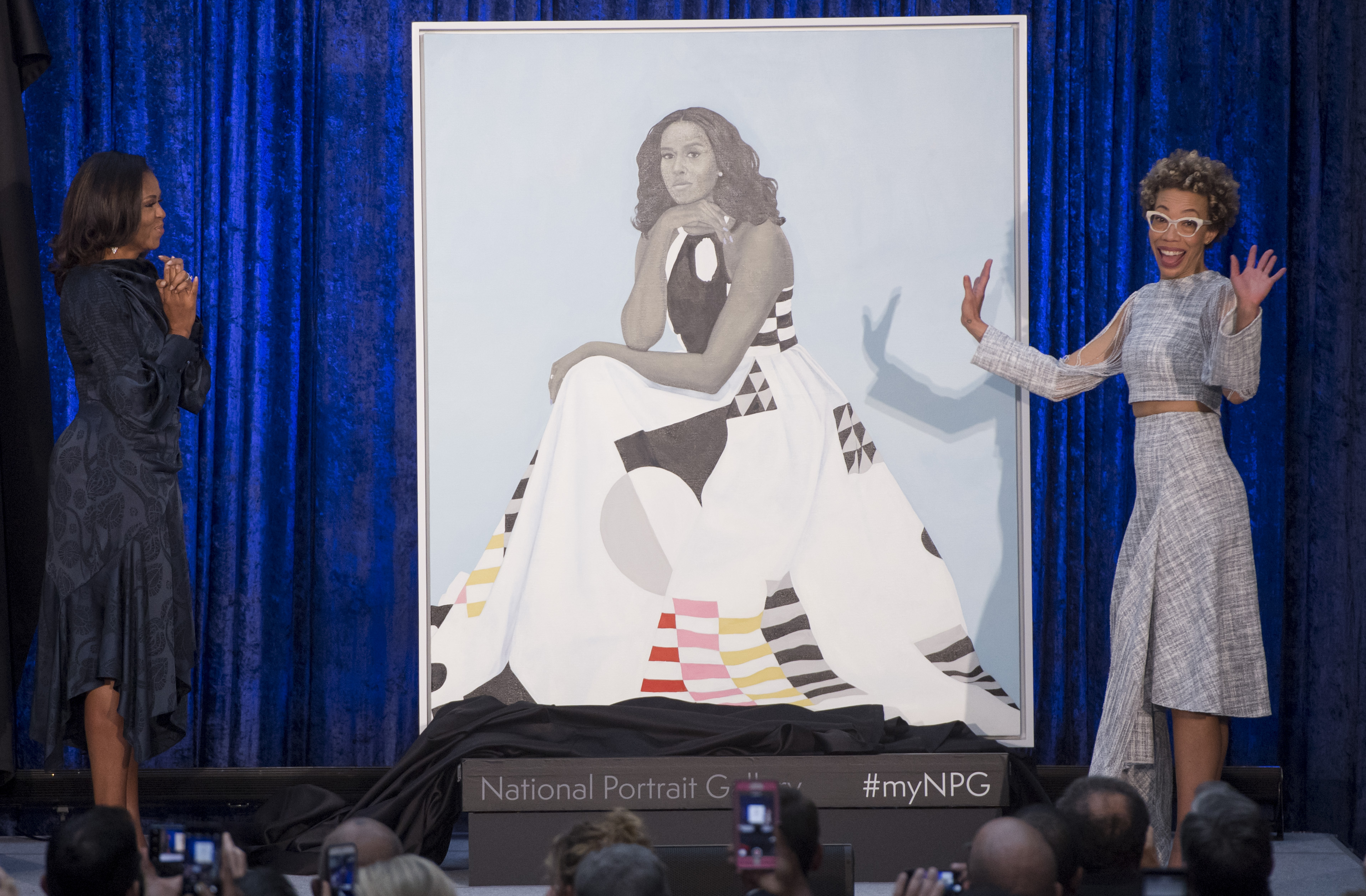 Former US First Lady Michelle Obama (L) and artist Amy Sherald (R) unveil Mrs. Obama's portrait at the Smithsonian's National Portrait Gallery. SAUL LOEB/AFP/Getty Images