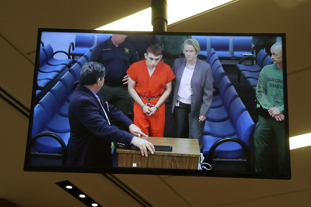 Nikolas Cruz, 19, a former student at Marjory Stoneman Douglas High School in Parkland, Florida, where he allegedly killed 17 people, is seen on a closed circuit television screen during a bond hearing in front of Broward Judge Kim Mollica at the Broward County Courthouse on February 15, 2018 in Fort Lauderdale, Florida. Mr. Cruz is possibly facing 17 counts of premeditated murder in the school shooting. (CREDIT: Susan Stocker - Pool/Getty Images)