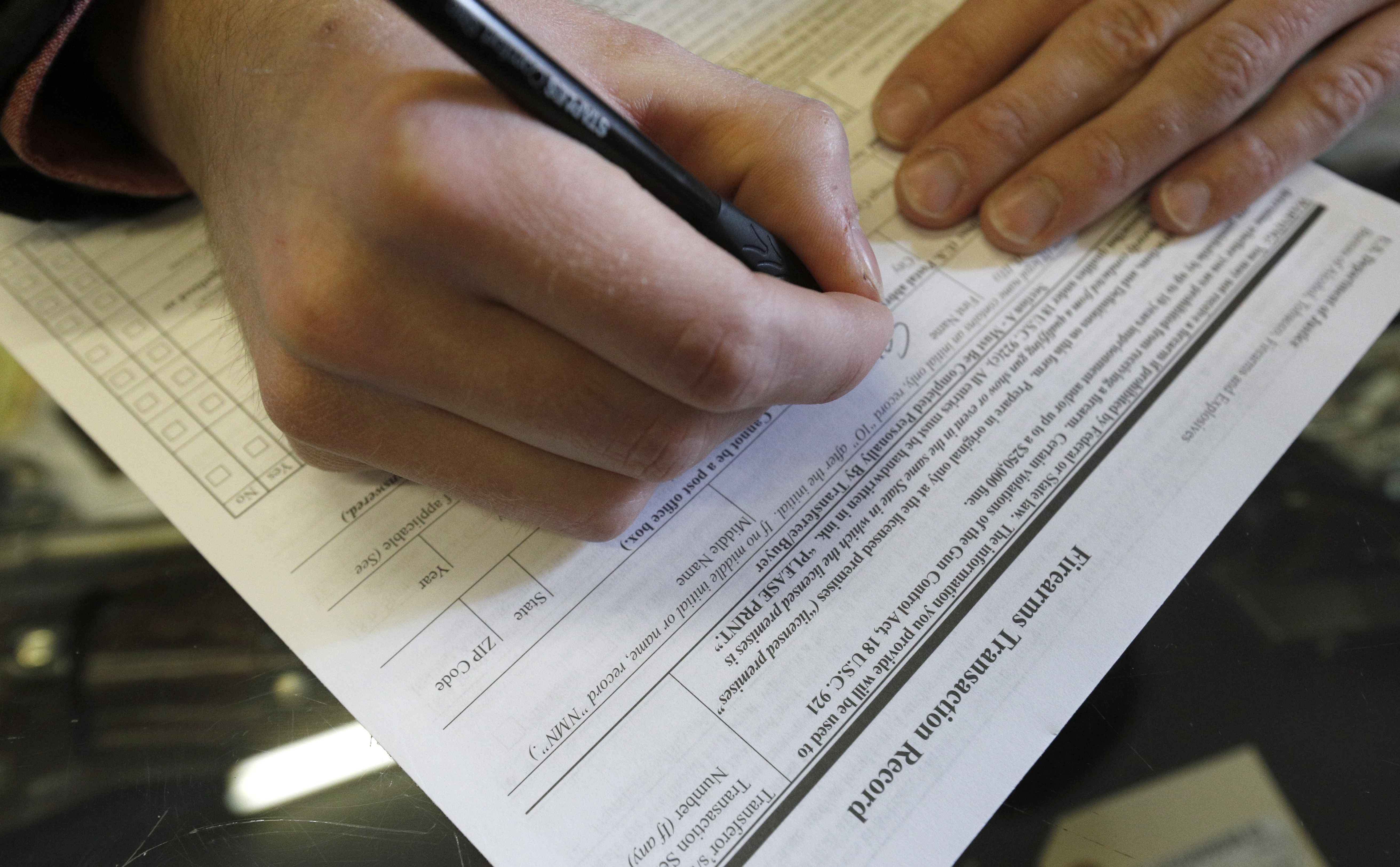 OREM, UT - FEBRUARY 15: A man fills out a federal background check form at Good Guys Guns & Range on February 15, 2018 in Orem, Utah. An AR-15 was used in the Marjory Stoneman Douglas High School shooting in Parkland, Florida. (Photo by George Frey/Getty Images)