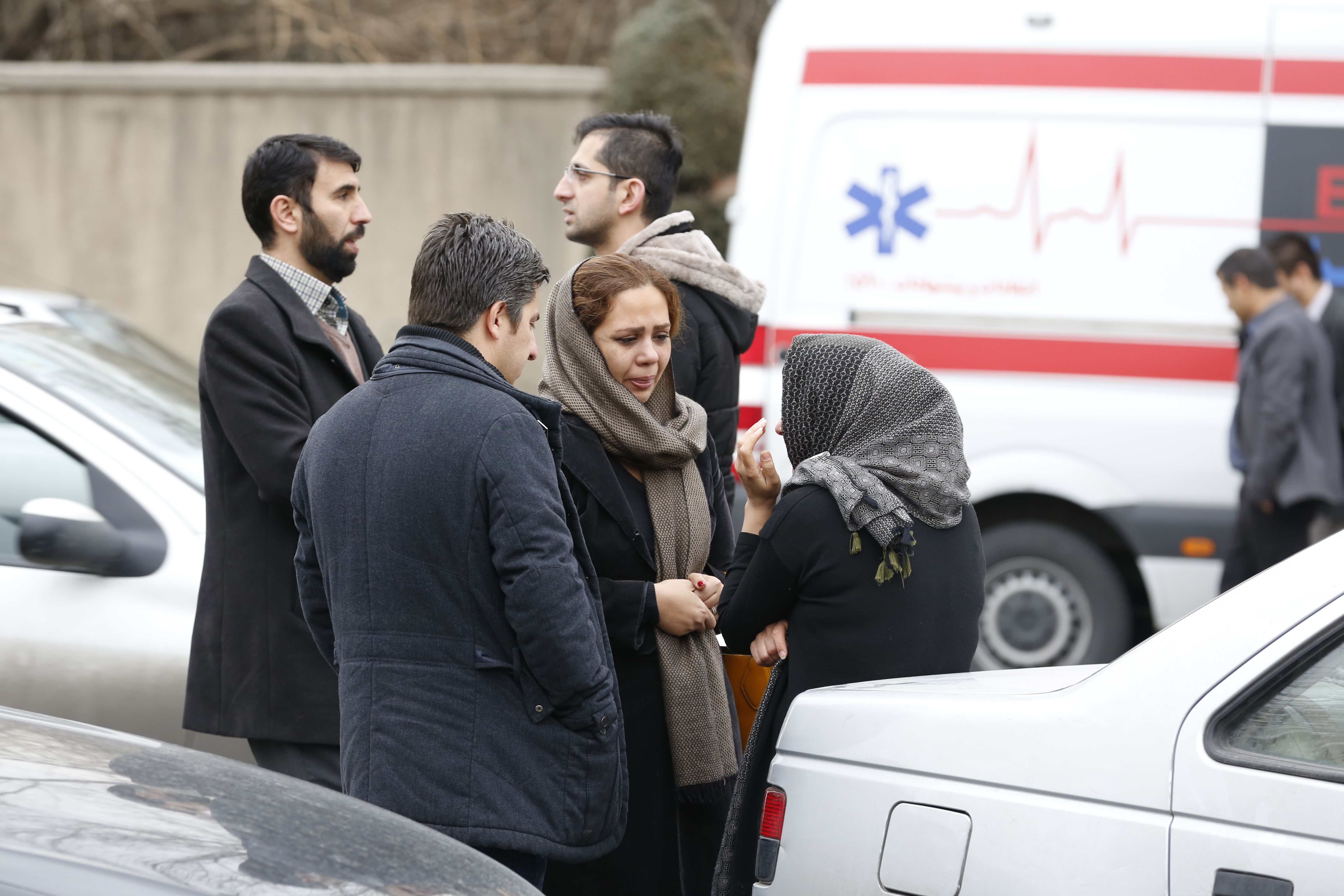 Relatives of Iranian passengers, onboard the Aseman Airlines flight EP3704, react as they gather in front of a mosque near Tehran's Mehrabad airport on February 18, 2018. (credit: ATTA KENARE/AFP/Getty Images)