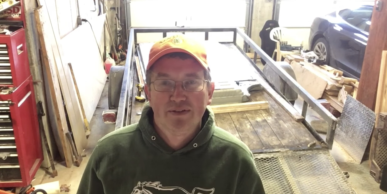 Screenshot of Rep. Thomas Massie (R-KY) in his garage, before he salvages a Tesla car battery pack to run his off-grid home.