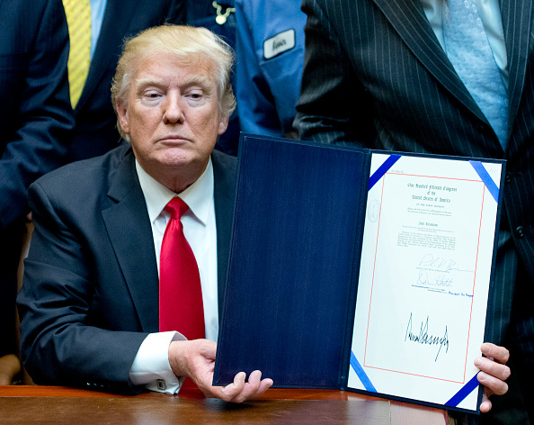 President Donald Trump signs resolution in February 2017 disapproving the Stream Protection Rule. CREDIT: Ron Sachs-Pool/Getty Images
