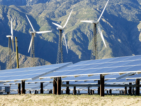 Solar panels and wind turbines with the San Jacinto Mountains in the background. CREDIT: Connie J. Spinardi/Getty Images