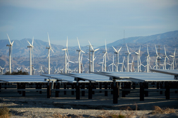 Wind turbines operate in front of solar panels in Palm Springs, California. CREDIT: Kevork Djansezian/Getty Images