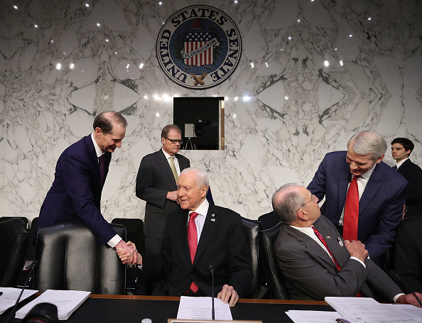 Chairman Orrin Hatch (R-UT) (2ndL), is greeted by Sen. Ron Wyden (D-OR) (L), while Sen. Rob Portman (R-OH) (R) greets Sen. Chuck Grassley (R-IA), during a Senate Finance Committee markup of the Tax Cuts and Jobs Act legislation on Capitol Hill, November 13, 2017 in Washington, DC. (Photo by Mark Wilson/Getty Images)