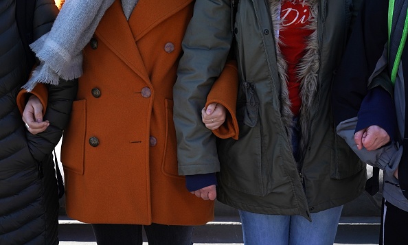 Students from Harvest Collegiate High School form a circle around the fountain in Washington Square Park on March 14, 2018 in New York to take part in a national walkout to protest gun violence, one month after the shooting in Parkland, Florida, in which 17 people were killed.
Students across the US walked out of classes on March 14, in a nationwide call for action against gun violence following the shooting deaths last month at a Florida high school. The nationwide protest is being held one month to the day after Nikolas Cruz, a troubled 19-year-old former student at Stoneman Douglas, unleashed a hail of gunfire on his former classmates.
/ AFP PHOTO / TIMOTHY A. CLARY (Photo credit should read TIMOTHY A. CLARY/AFP/Getty Images)