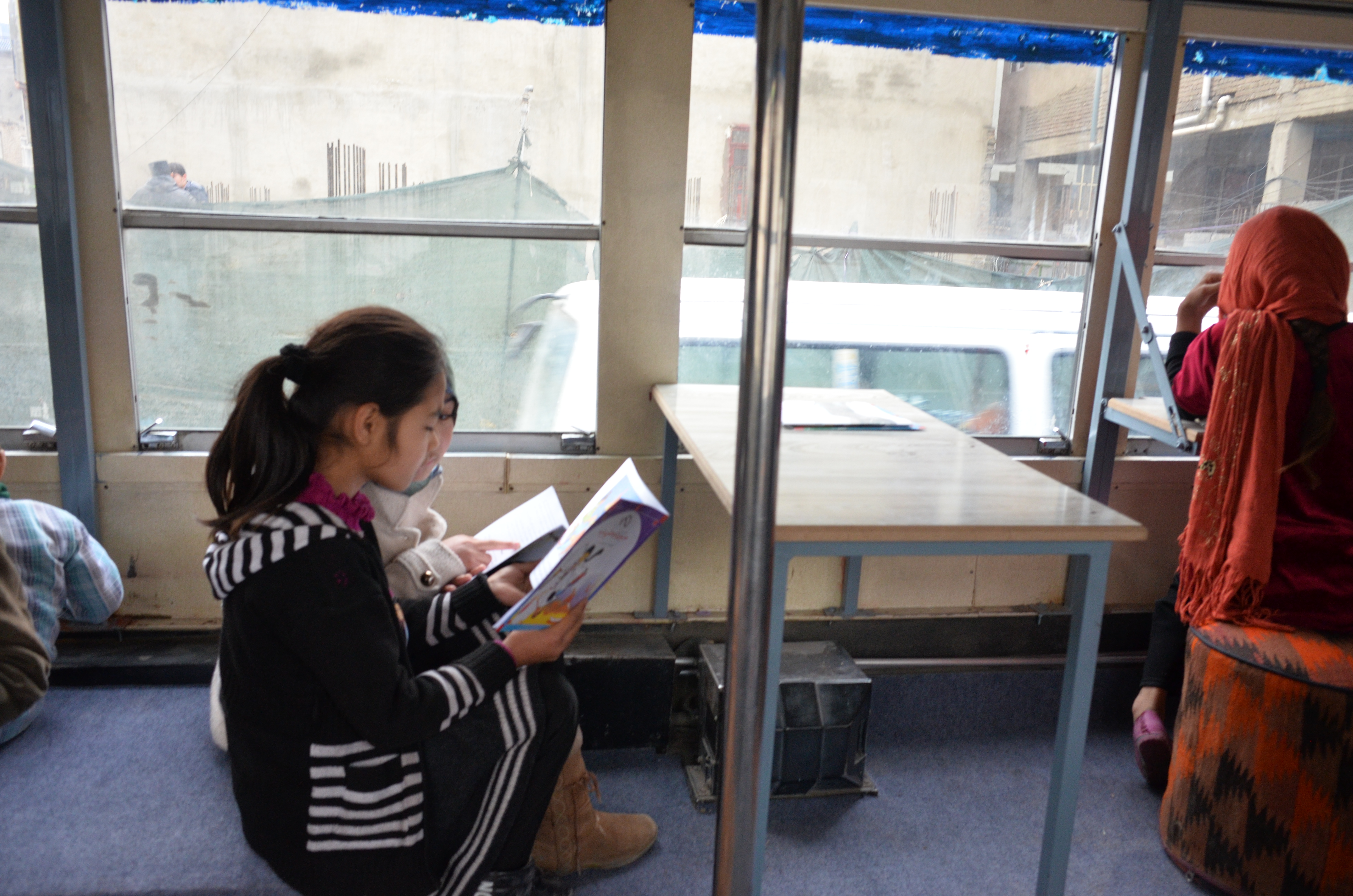 Afghan girls read at the Charmaghz library. (credit: Ali M. Latifi for ThinkProgress)