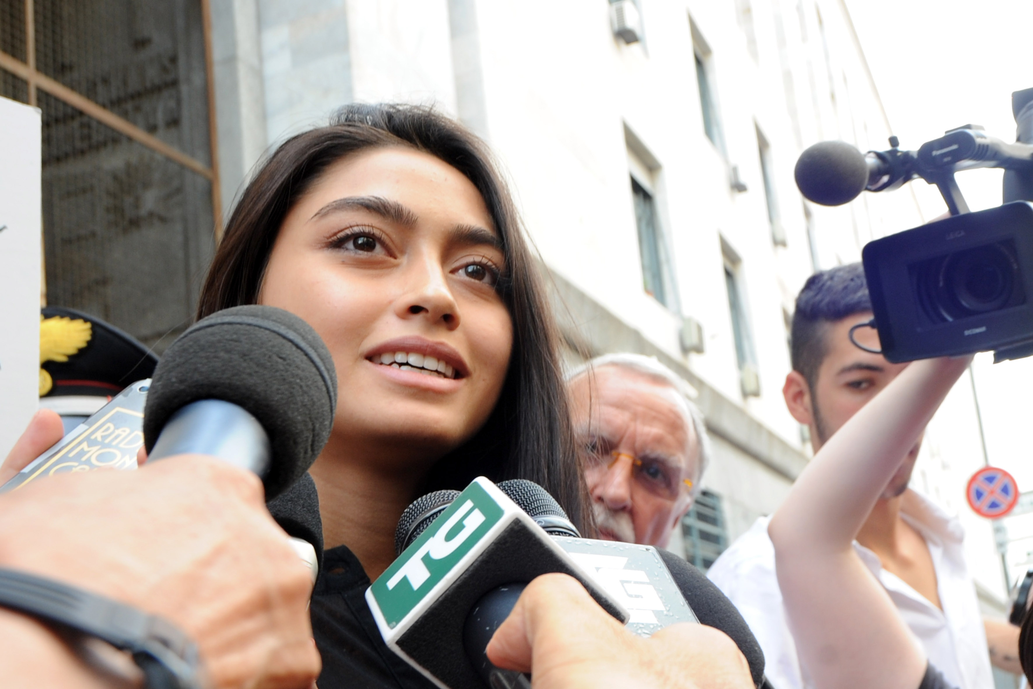 Ambra Battilana speaks to waiting media outside the courthouse after the verdicts in the 'Ruby bis' case on July 19, 2013 in Milan, Italy. CREDIT: Pier Marco Tacca/Getty Images