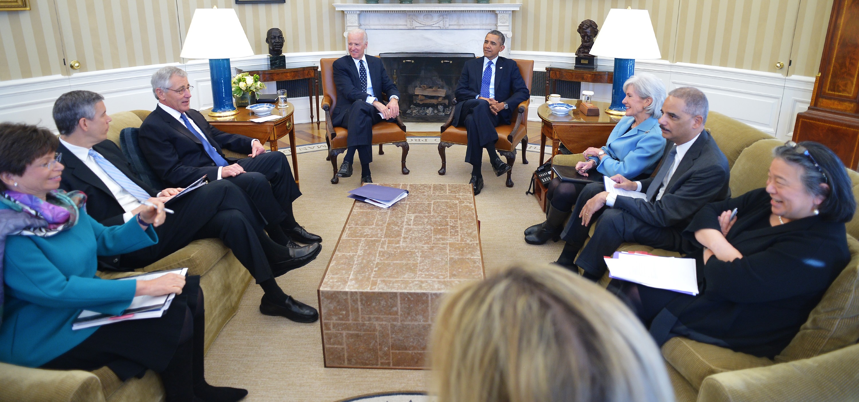 US President Barack Obama, Vice President Joe Biden and cabinet secretaries meet with the Council on Women and Girls in the Oval Office of the White House on January 22, 2014 in Washington, DC. From left: Chair of the White House Council on Women and Girls Valerie Jarrett, Education Secretary Arne Duncan, Defense Secretary Chuck Hagel, Biden, Obama, Health and Human Services Secretary Kathleen Sebelius, Attorney General Eric Holder, and Executive Director of the White House Council on Women and Girls Tina Tchen. CREDIT: MANDEL NGAN/AFP/Getty Images