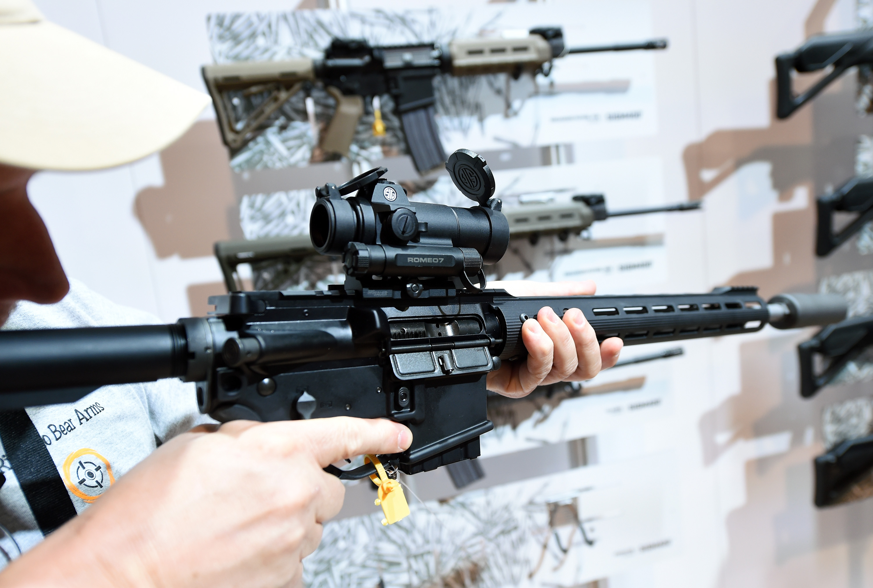 A convention attendee tries out a Predator SIGM400 rifle at the 2016 National Shooting Sports Foundation's Shooting, Hunting, Outdoor Trade (SHOT) Show at the Sands Expo and Convention Center on January 19, 2016 in Las Vegas, Nevada. (credit: Ethan Miller/Getty Images)