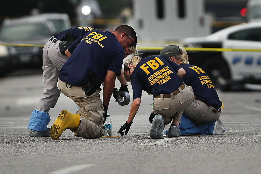 Members of an FBI evidence response team search an area that is still an active crime scene in downtown Dallas following the deaths of five police officers on Thursday evening on July 9, 2016 in Dallas, Texas. (CREDIT: Spencer Platt/Getty Images)