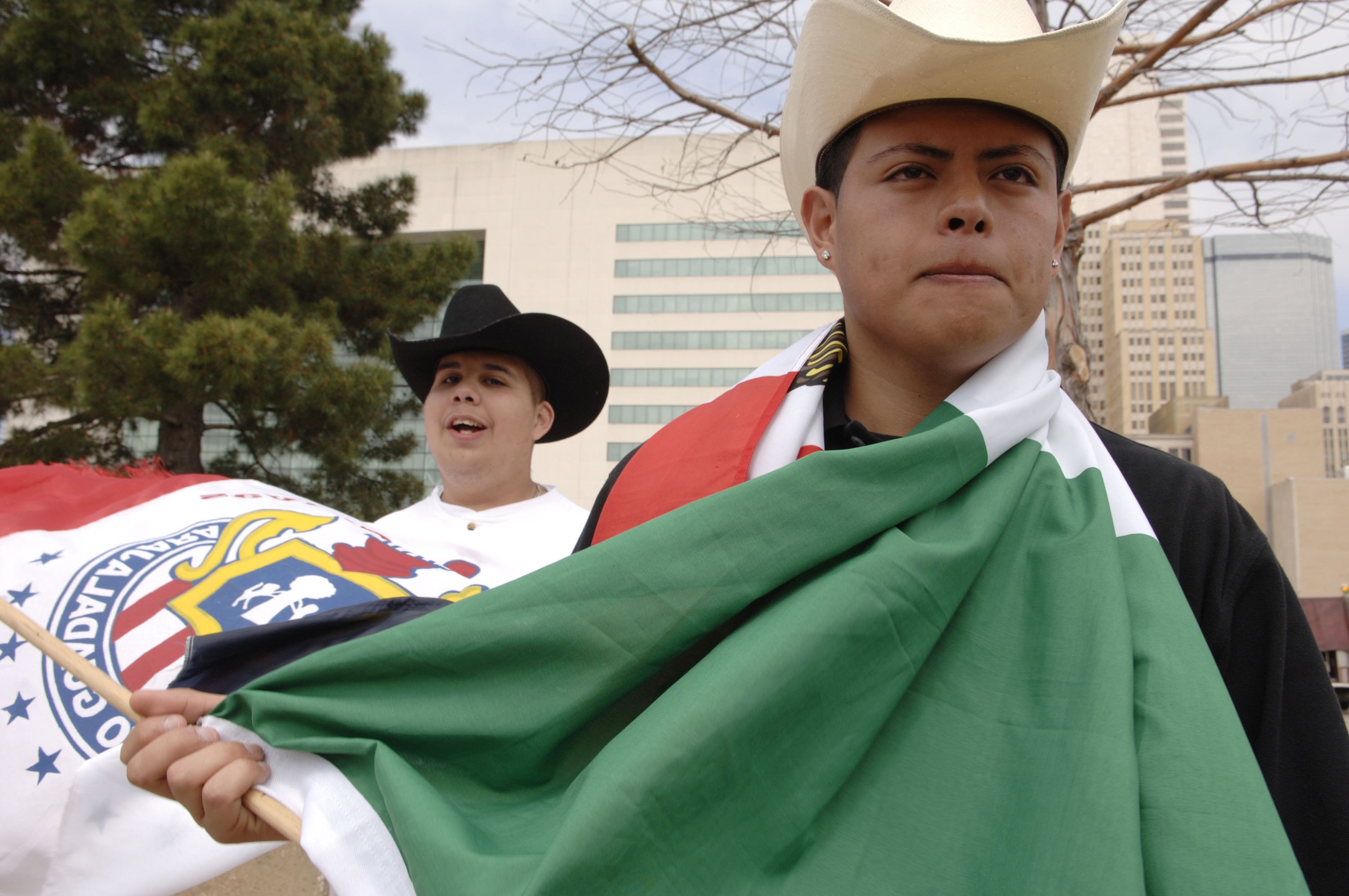 Hector Cruz and Miguel Miranda protest immigration policy in front of the Dallas City Hall on March 28, 2006 in Dallas Texas. CREDIT: Jensen Walker/Getty Images
