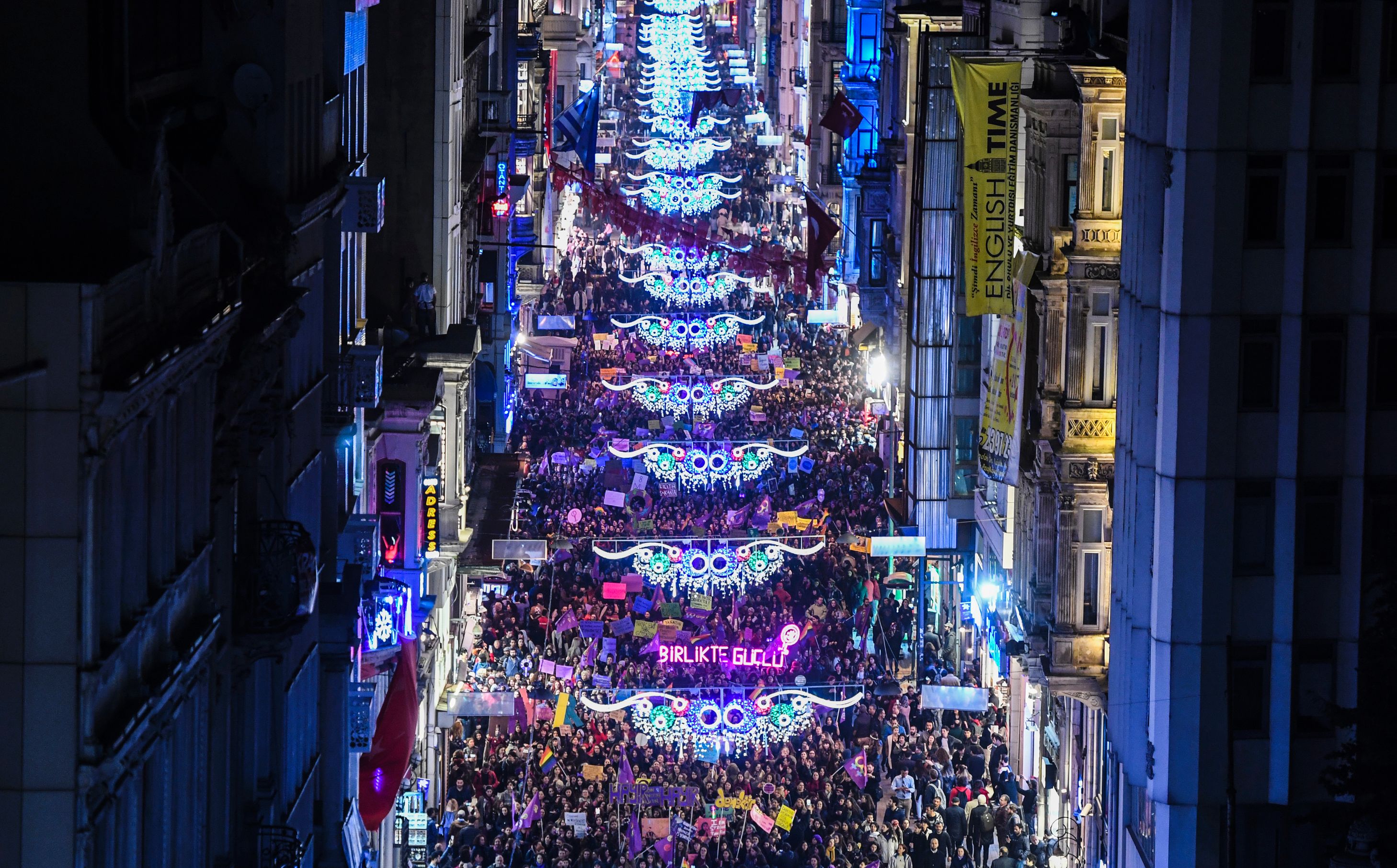 Thousands of people march down Istiklal Avenue during a feminist night march to mark International Women's Day in Istanbul on March 8, 2017. (CREDIT: BULENT KILIC/AFP/Getty Images)