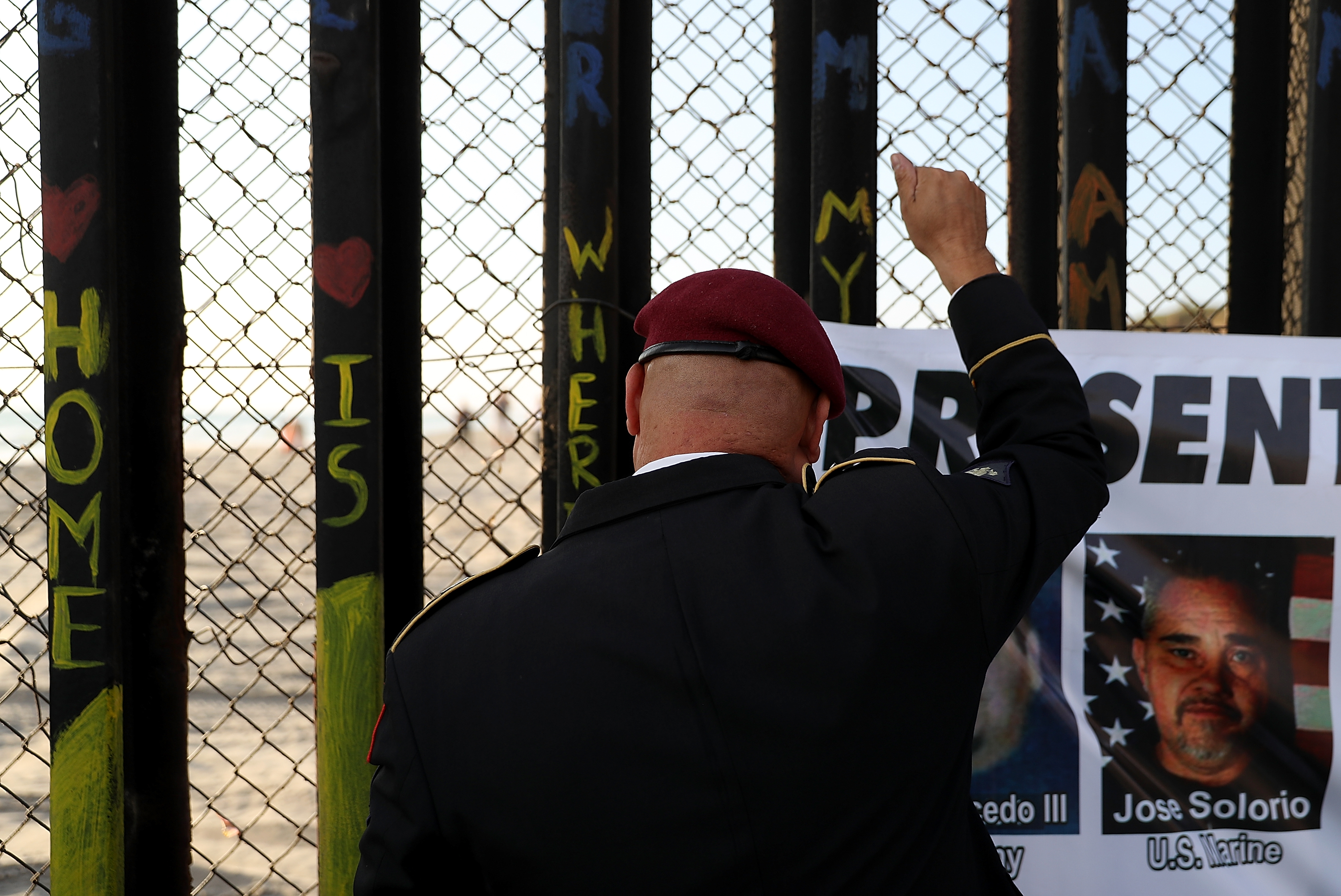 TIJUANA, MEXICO - JULY 04: Deported U.S. Army veteran Hector Barajas looks through the US-Mexican border fence during a Fourth of July gathering on the beach at Playas de Tijuana on July 4, 2017 in Tijuana, Mexico. The Deported Veterans Support House, also known as "The Bunker" was founded by deported U.S. Army veteran Hector Barajas to support deported veterans by offering food, shelter, clothing as well as advocating for political legislation that would prohibit future deportations of veterans. There are an estimated 11,000 non-citizens serving in the U.S. military and most will be naturalized during or following their service. Those who leave the military early or who are convicted of a crime after serving can be deported. (Photo by Justin Sullivan/Getty Images)