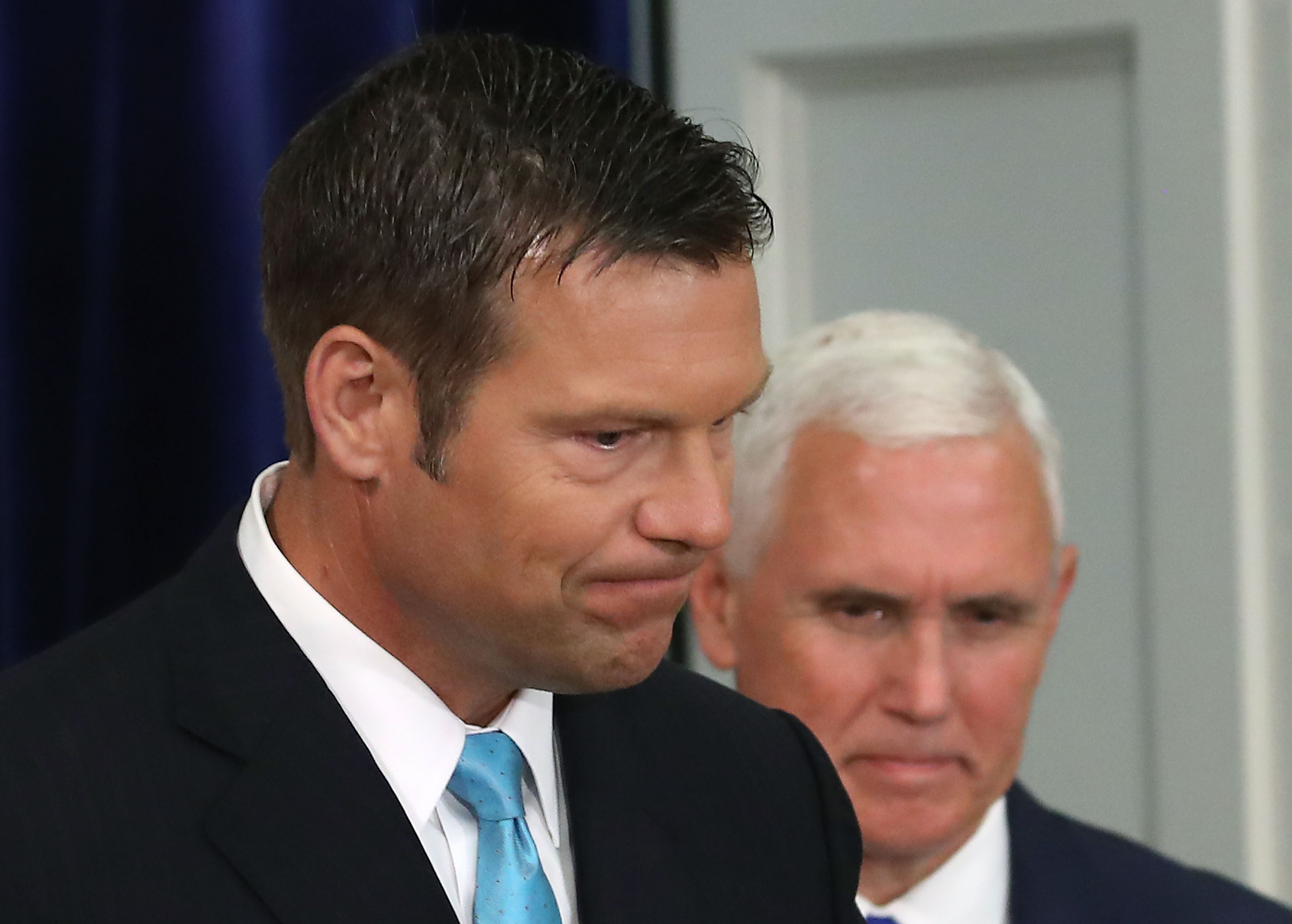 Kansas Secretary of State, Kris Kobach (L) and US Vice President Mike Pence, attend the first meeting of the Presidential Advisory Commission on Election Integrity in the Eisenhower Executive Office Building, on July 19, 2017 in Washington, DC. CREDIT: Photo by Mark Wilson/Getty Images