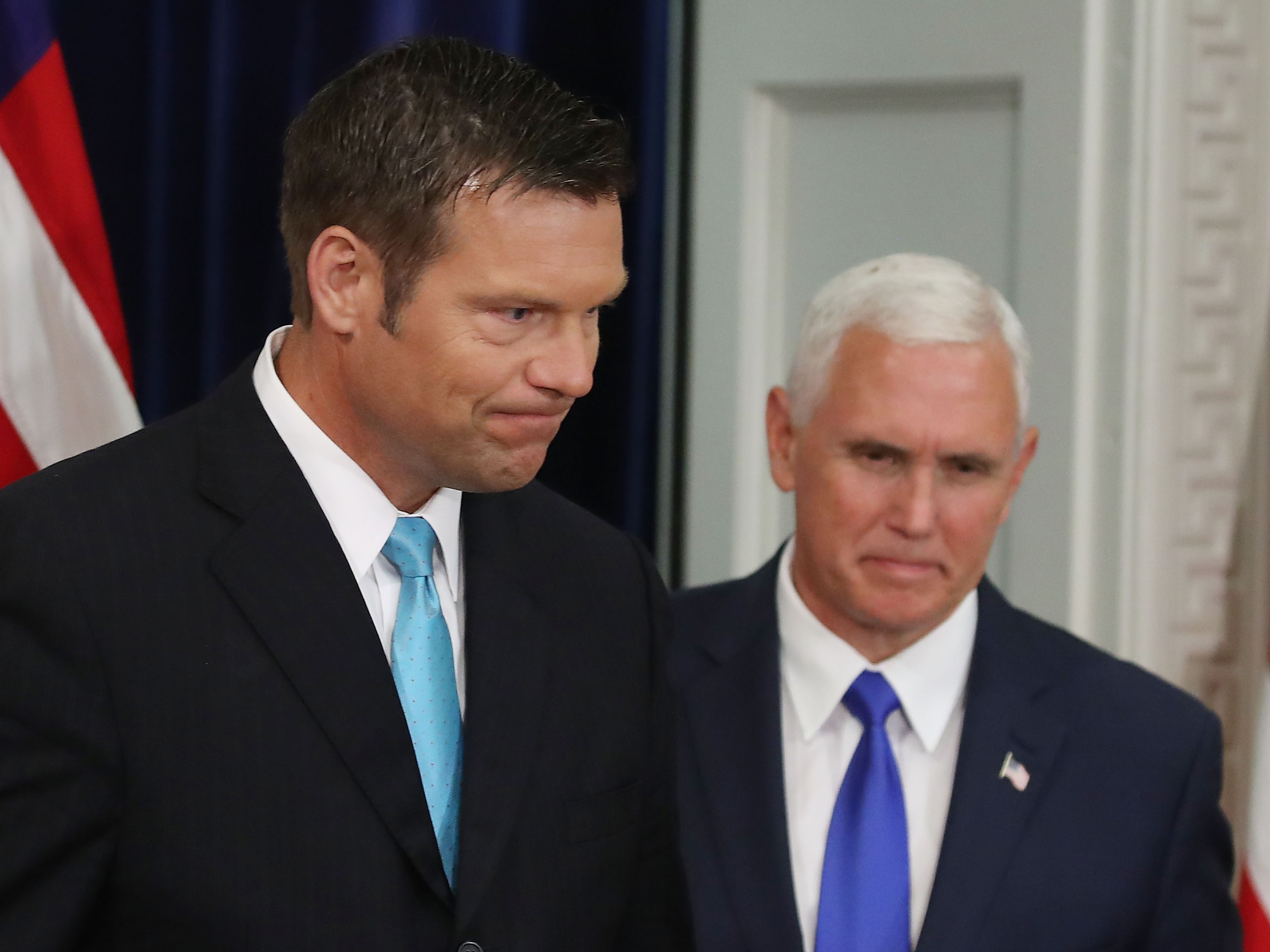 Kansas Secretary of State, Kris Kobach (L) and US Vice President Mike Pence, attend the first meeting of the Presidential Advisory Commission on Election Integrity in the Eisenhower Executive Office Building, on July 19, 2017 in Washington, DC. CREDIT: Photo by Mark Wilson/Getty Images