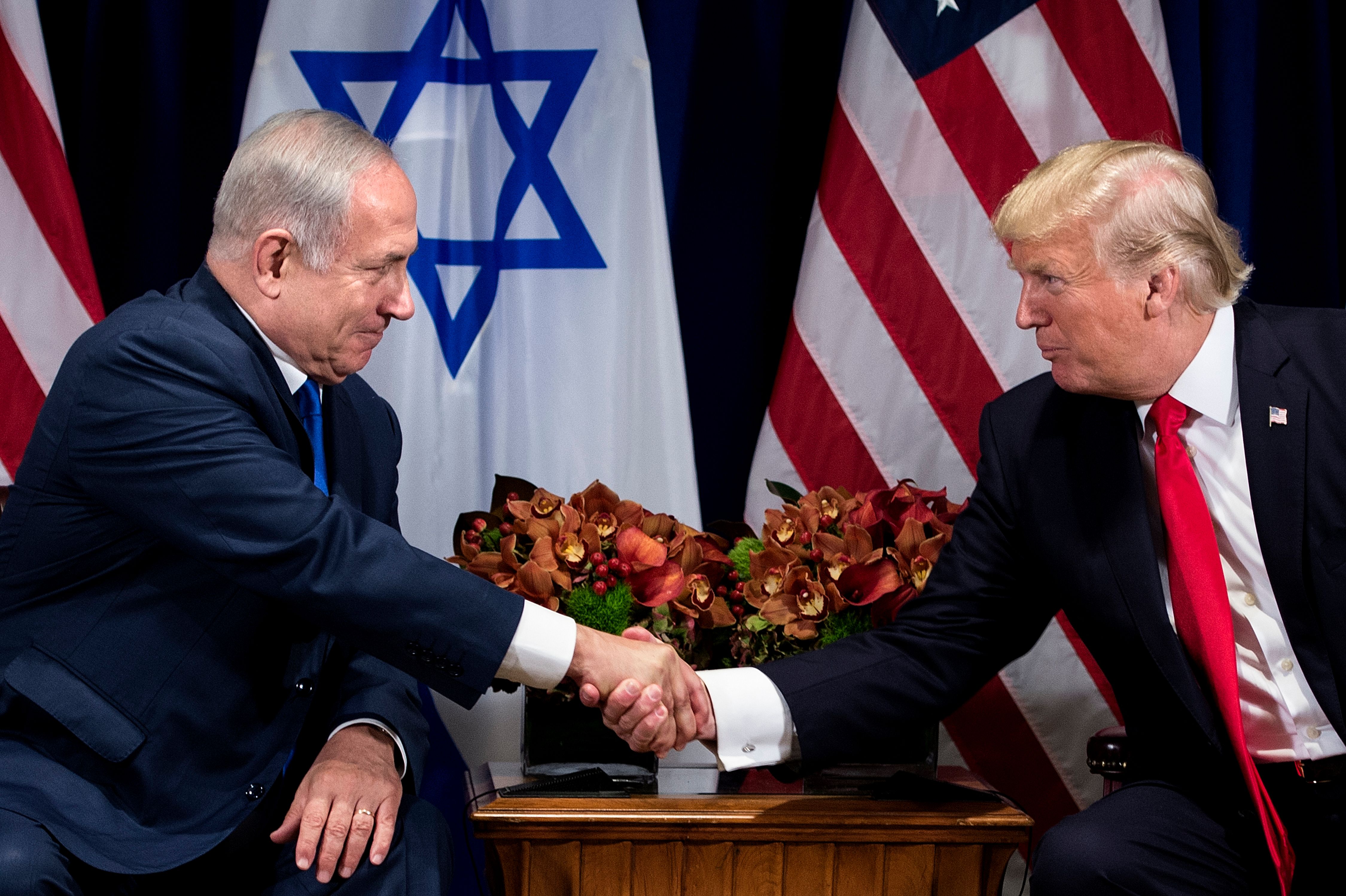 Israel's Prime Minister Benjamin Netanyahu and US President Donald Trump shake hands before a meeting at the Palace Hotel during the 72nd session of the United Nations General Assembly on September 18, 2017, in New York. (CREDIT: Brendan Smialowski/AFP/Getty Images)