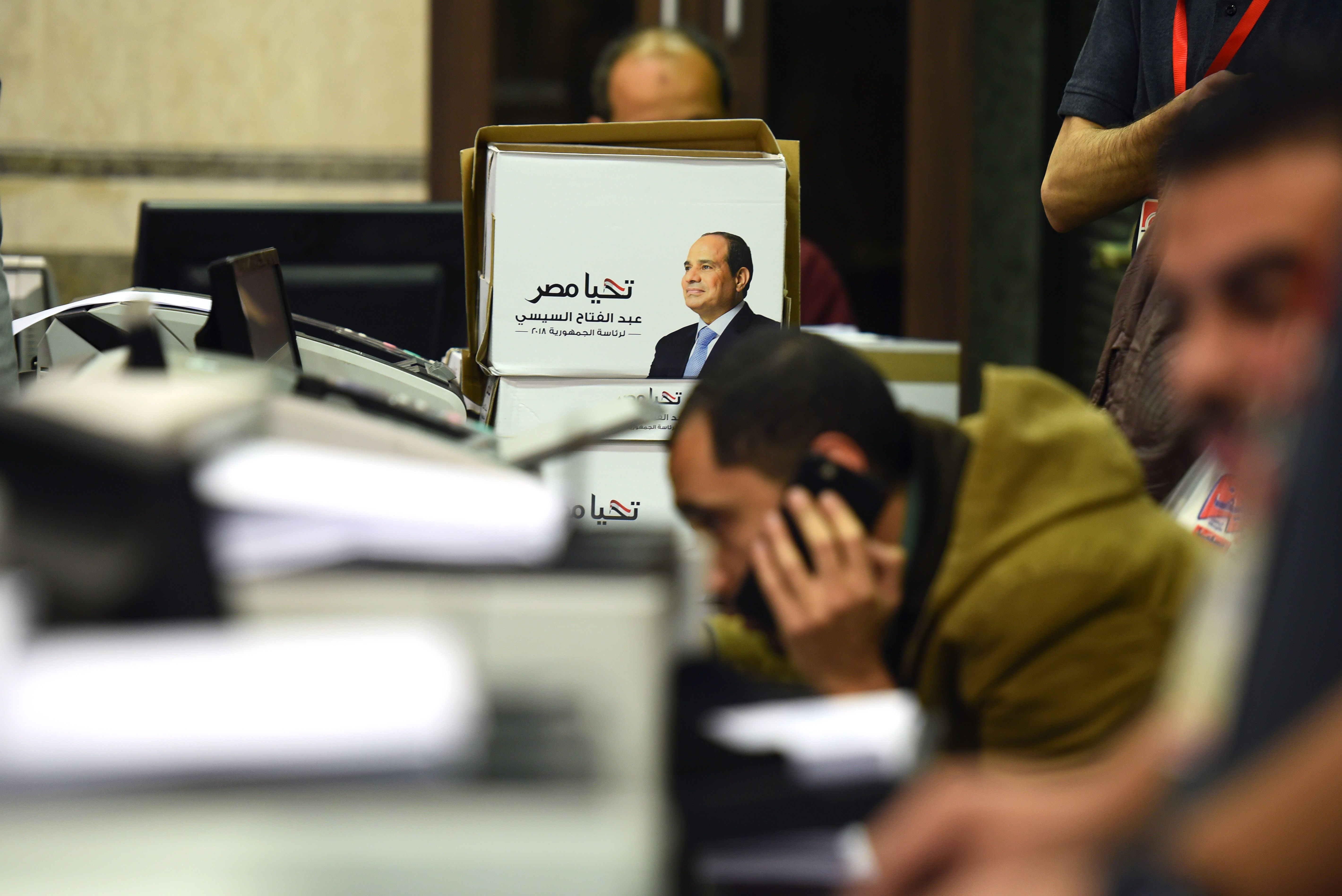 Members of Egyptian President Abdel Fattah al-Sisi presidential campaign staff sift through boxes containing signatures in his support, needed to register for the elections, at the National Election Authority, in Cairo on January 24, 2018.
(CREDIT: Mohamed El-Shahed/AFP/Getty Images)