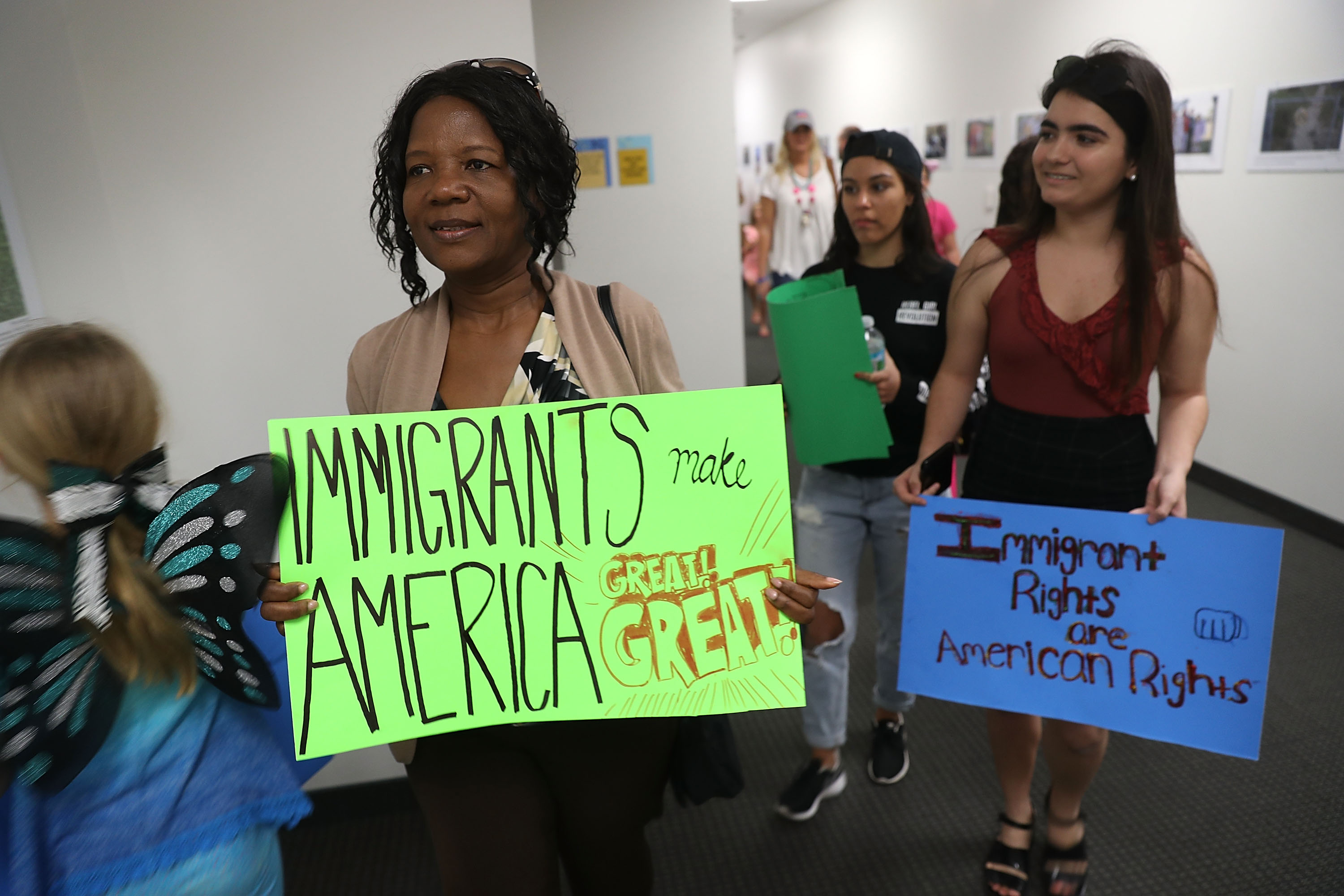 WEST PALM BEACH, FL - FEBRUARY 02: Anne Pierre (C) joins with other activists in front of the office of Sen. Bill Nelson (D-FL) to ask him to help recipients of the Deferred Action for Childhood Arrivals (DACA) as well as all immigrants living in America on February 2, 2018 in West Palm Beach, Florida. (Photo by Joe Raedle/Getty Images)