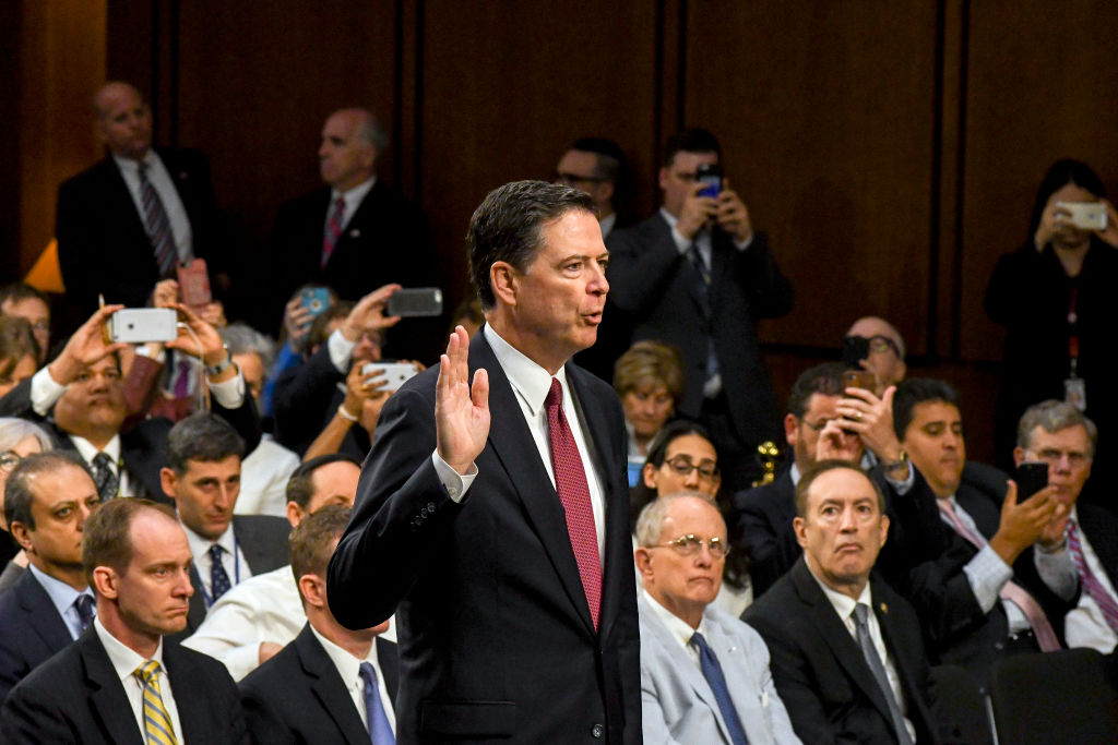 Former FBI Director James Comey (center) is sworn in before his testimony before the Senate Intelligence Committee, Washington DC, June 8, 2017. (CREDIT: Mark Reinstein/Corbis via Getty Images)