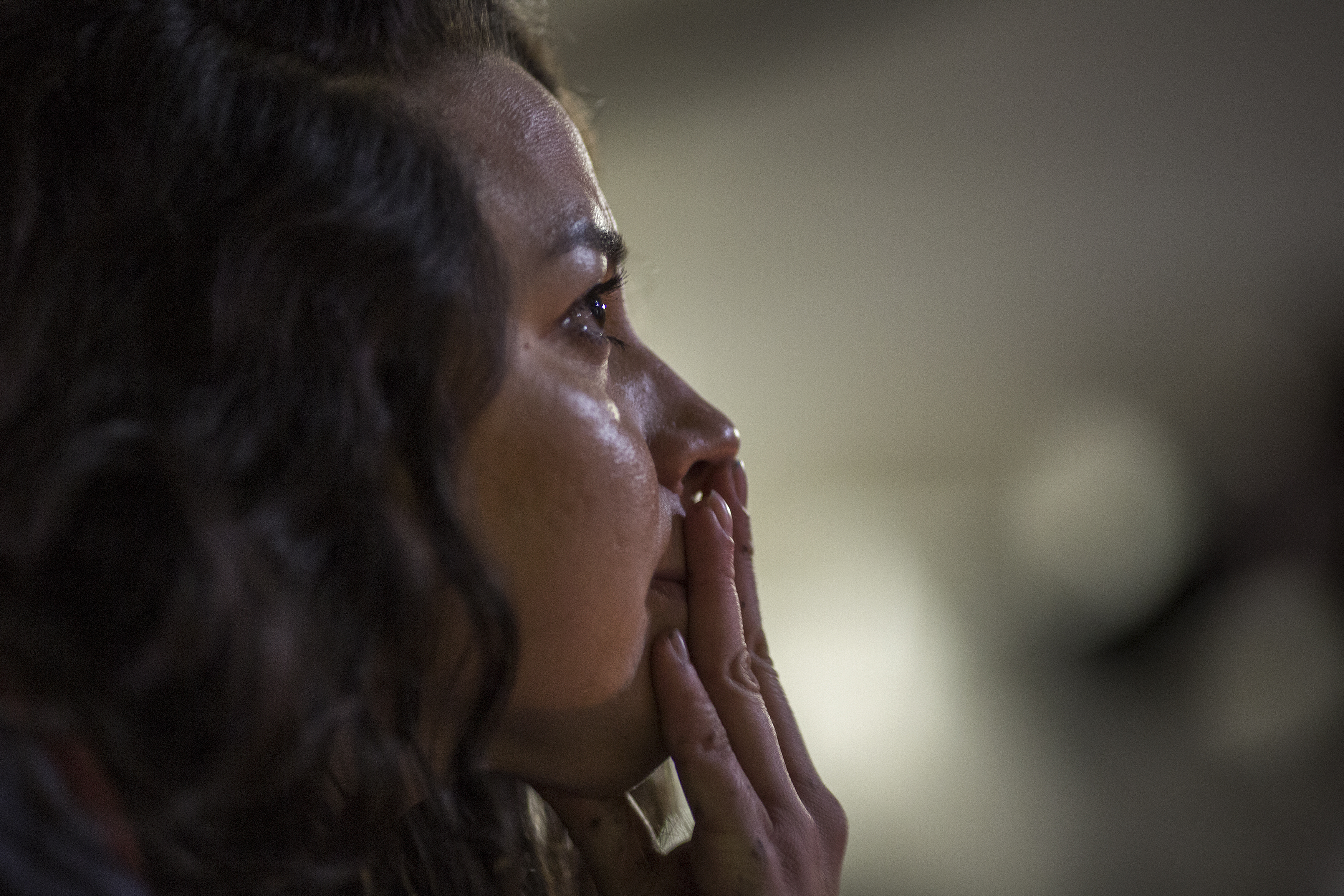 A woman listens to a speaker as so-called Dreamers, children who grew up in the United States after arriving with their undocumented parents, rally outside the Metropolitan Detention Center on February 28, 2018 in Los Angeles, California. (CREDIT: David McNew/Getty Images)