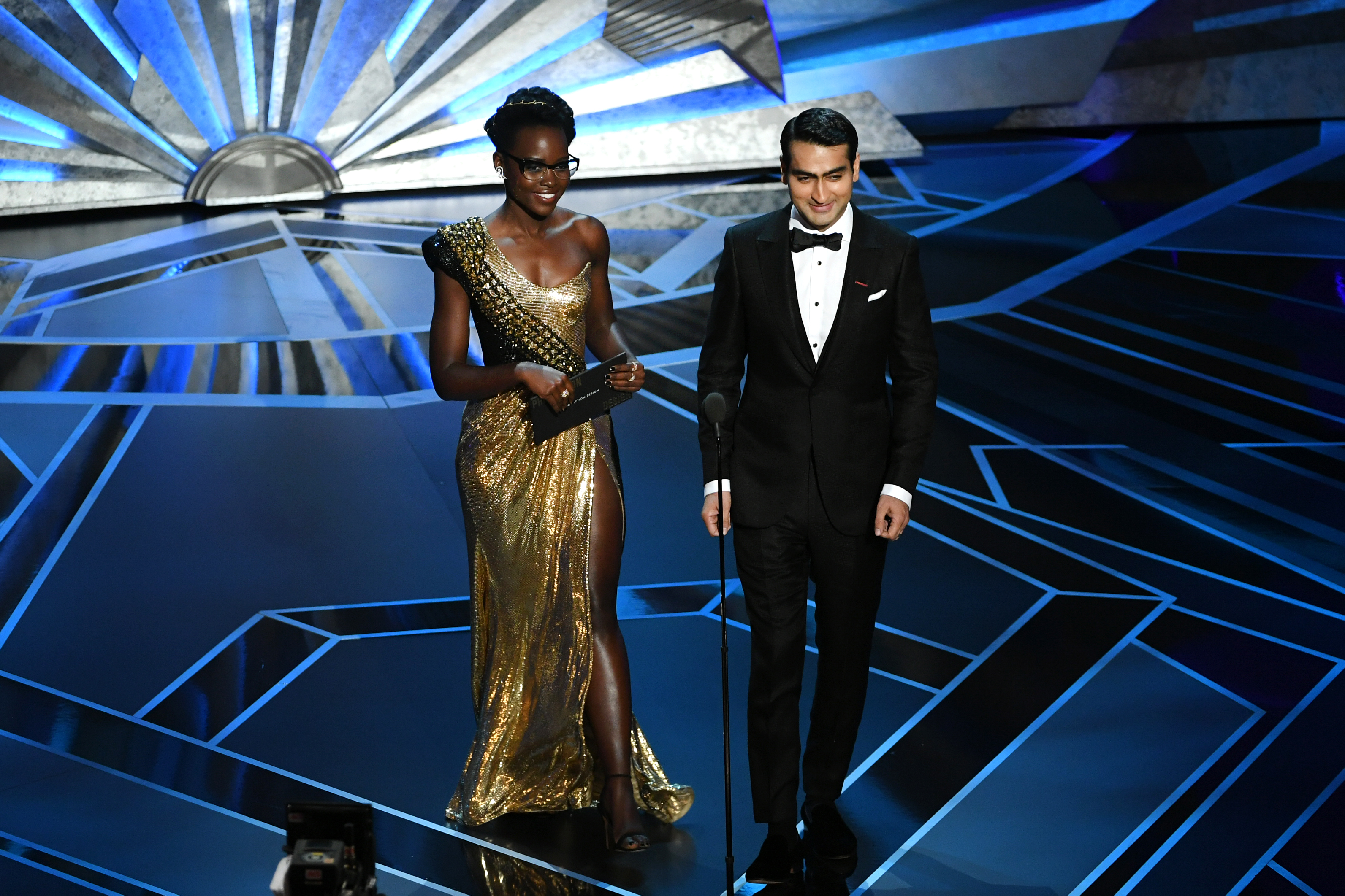 Actors Lupita Nyong'o (L) and Kumail Nanjiani walk onstage during the 90th Annual Academy Awards at the Dolby Theatre. CREDIT: Photo by Kevin Winter/Getty Images
