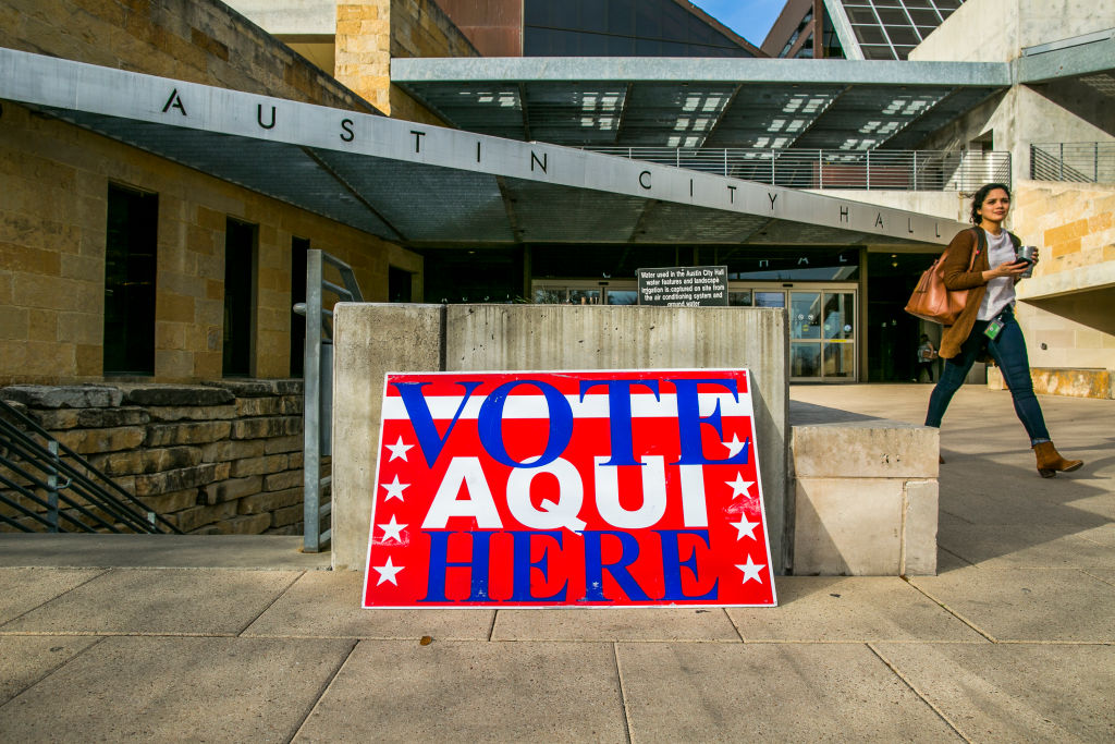 AUSTIN, TX - MARCH 06: A pedestrian walks past Austin City Hall, an early voting center, on March 6, 2018 in Austin, Texas. Democrats are seeing a large increase in voter turnourt compared to last year. CREDIT: Drew Anthony Smith/Getty Images