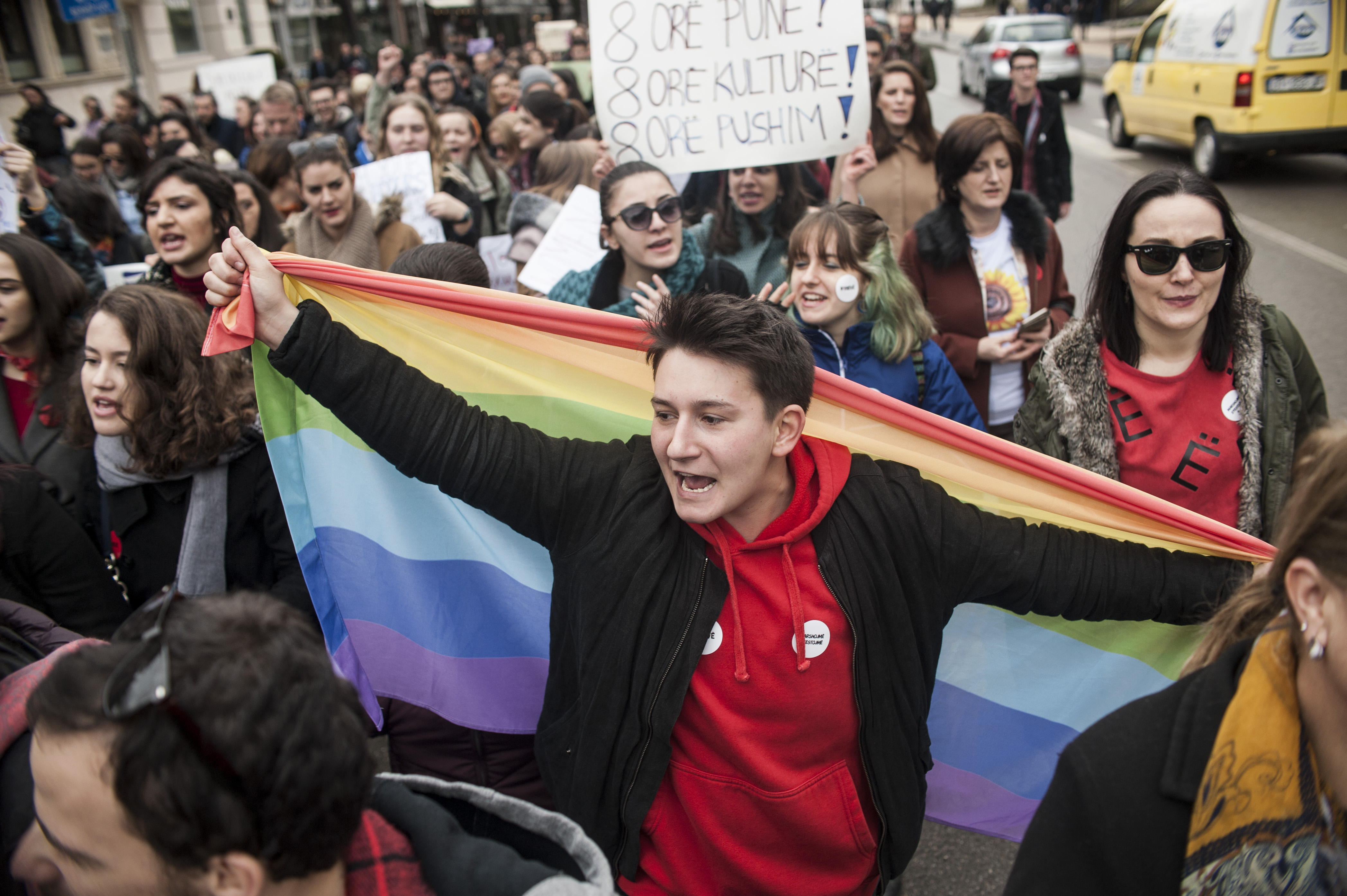 A woman displays the "Rainbow Flag" during a rally for gender equality and against violence towards women to mark the International Women's Day in Pristina on March 8, 2017. (CREDIT: ARMEND NIMANI/AFP/Getty Images)