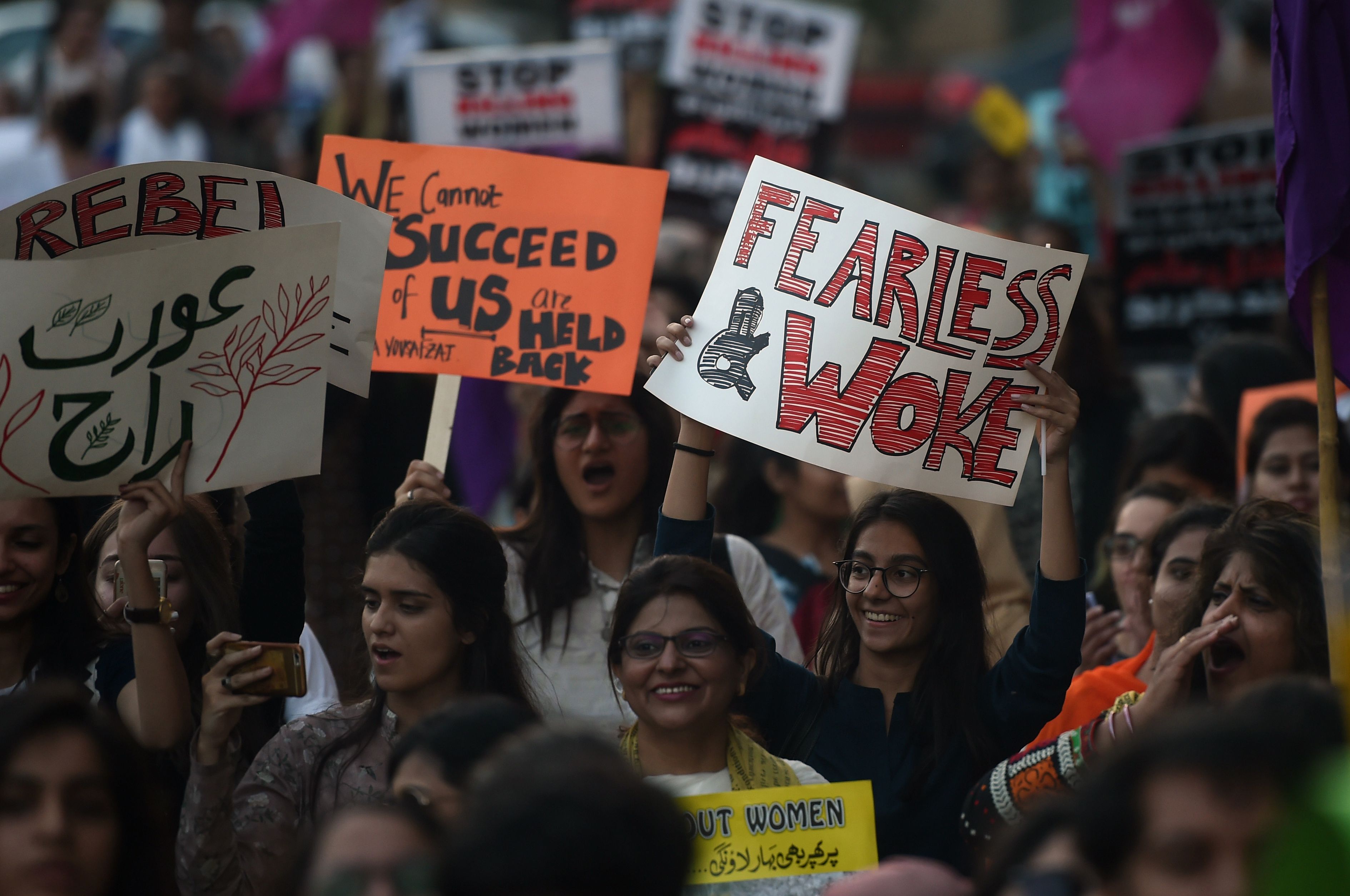 Pakistani civil society activists carry placards as the march during a rally to mark International Women's Day in Karachi on March 8, 2018. (CREDIT: ASIF HASSAN/AFP/Getty Images)