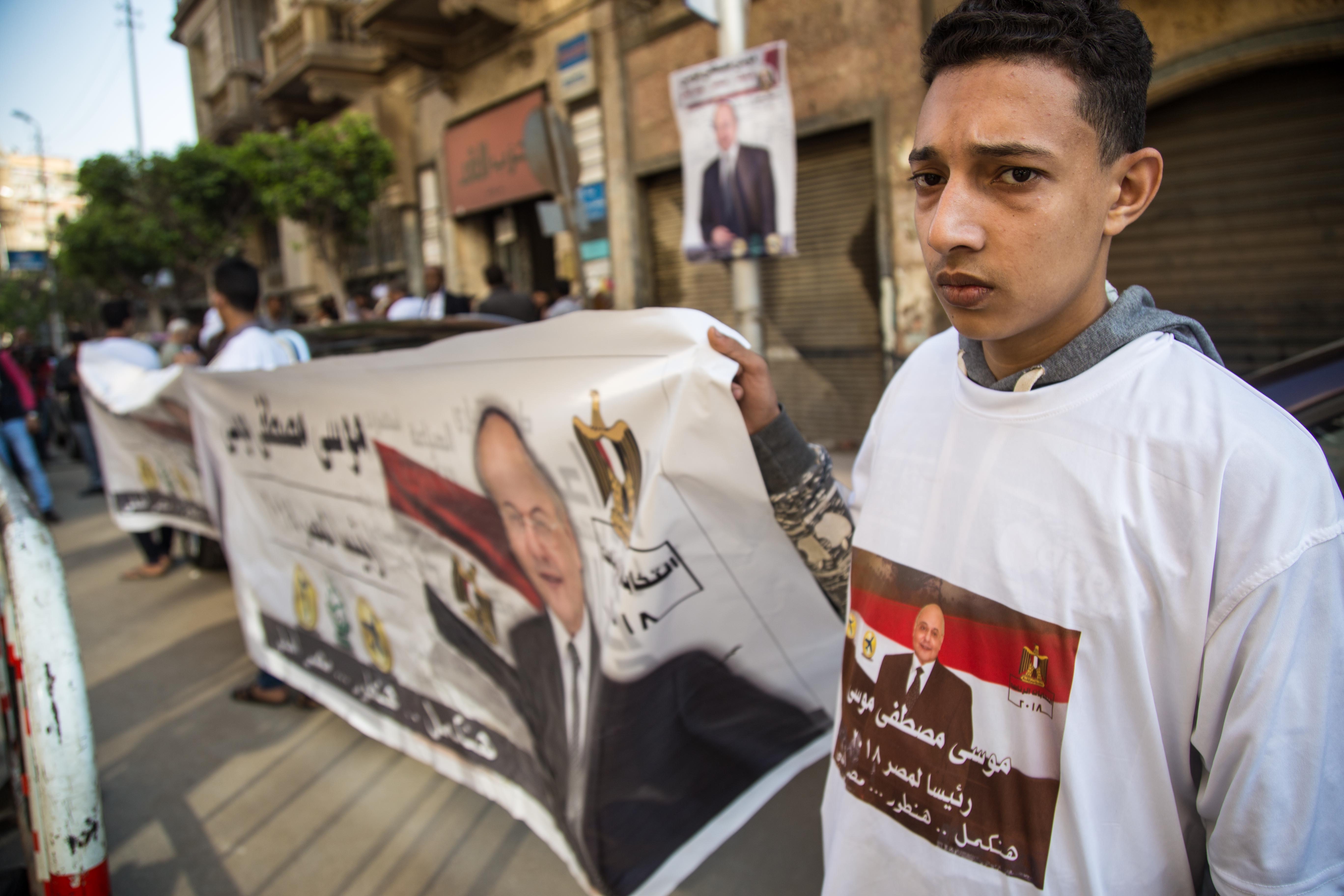 Supporters of the Liberal el-Ghad Party candidate Moussa Mostafa Moussa -- Sisi's only opponent in the presidential poll -- hold his campaign banners during a pre-election campaign rally in front of Al Ghad Party headquarter in downtown Cairo in Cairo, Egypt, on 10 March 2018. CREDIT: Ezzat/NurPhoto/Getty Images.